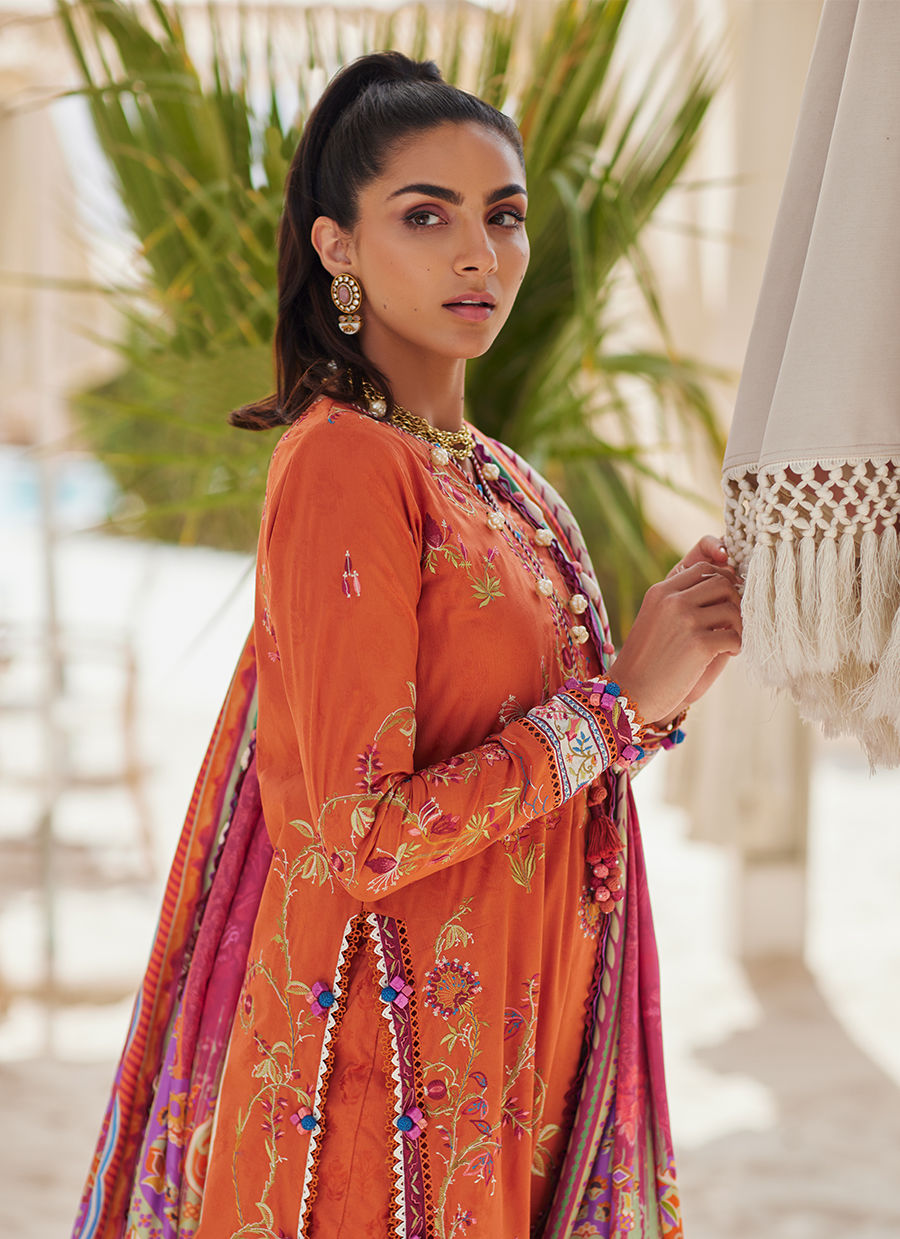Model wearing rust orange embroidered outfit from Farah Talib Aziz, Unstitched Luxury '25, ideal for Pakistani clothes online in UK.