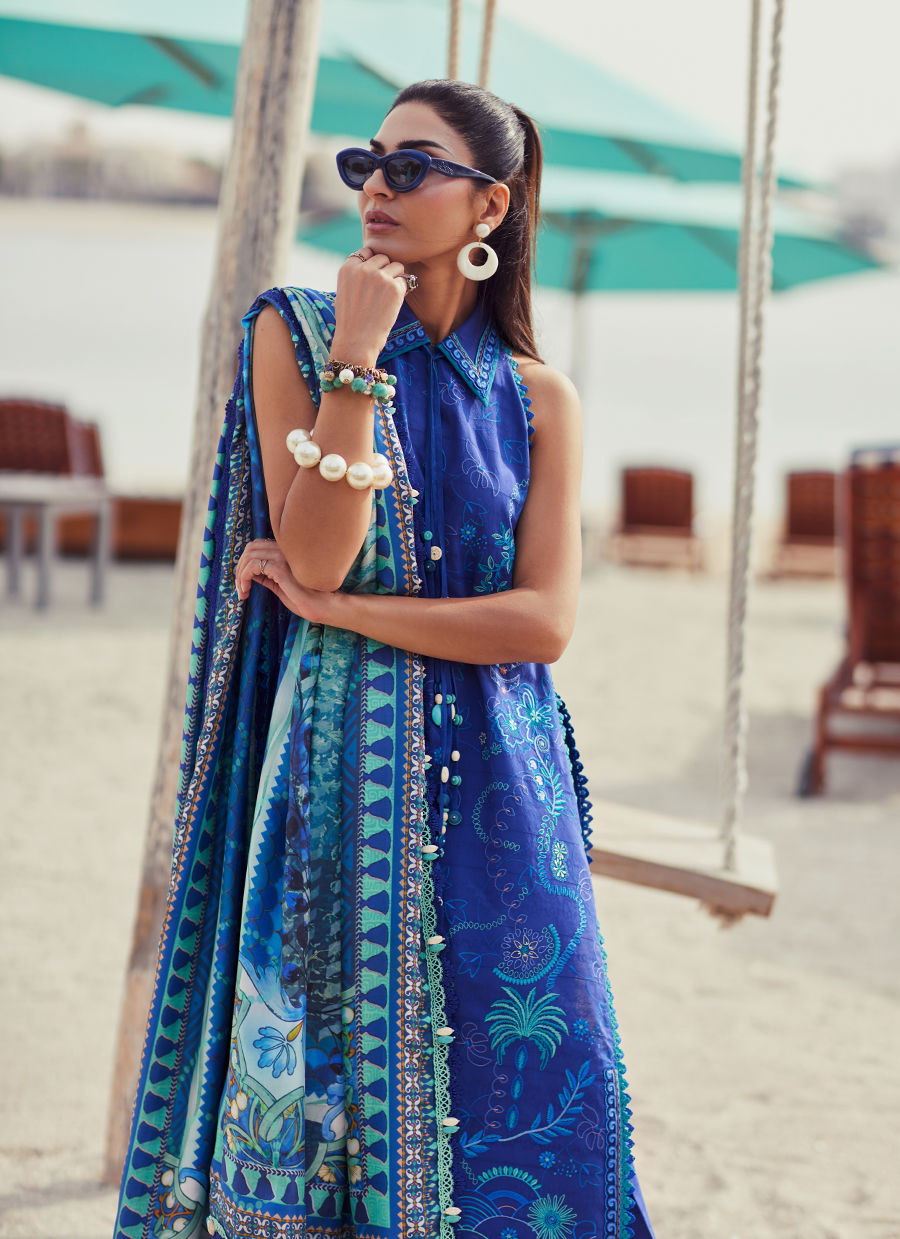 Model wearing a deep blue embroidered outfit from Farah Talib Aziz, Unstitched Luxury '25, ideal for Pakistani luxury pret lovers in UK.