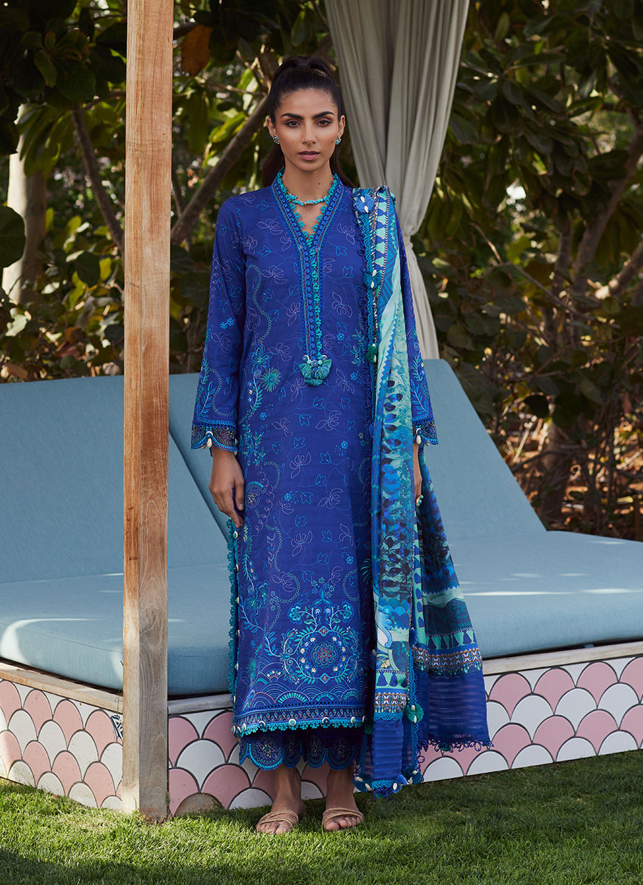 Model wearing a deep blue embroidered outfit from Farah Talib Aziz, Unstitched Luxury '25, ideal for Pakistani luxury pret lovers in UK.