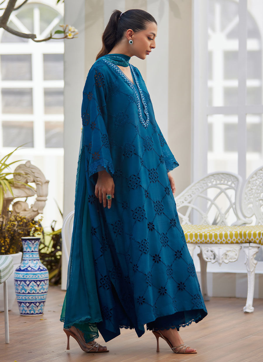 Model wearing teal blue embroidered dress with mirror detailing from Farah Talib Aziz, perfect for Pakistani luxury pret online in UK.