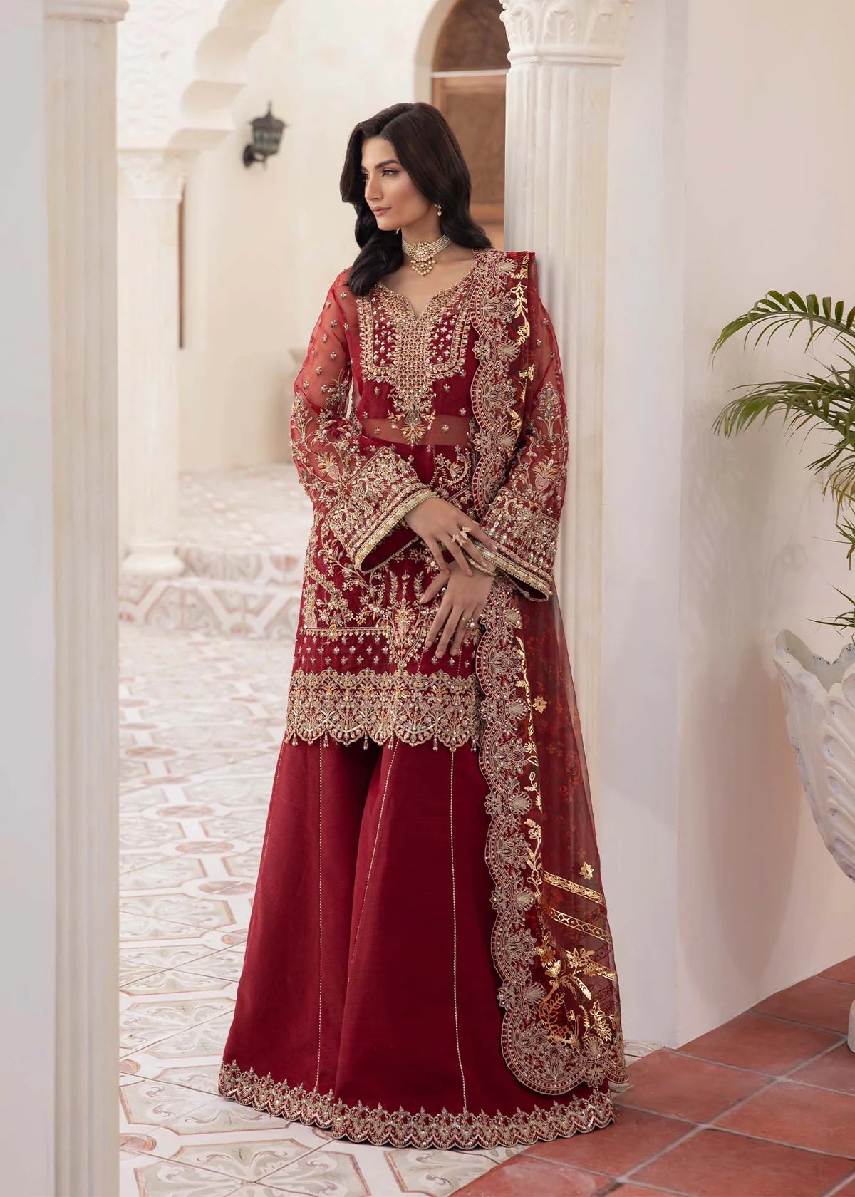 Model wearing deep red Zehrah outfit from Kanwal Malik with gold embroidery—Pakistani luxury pret perfect for weddings, shop in UK online.