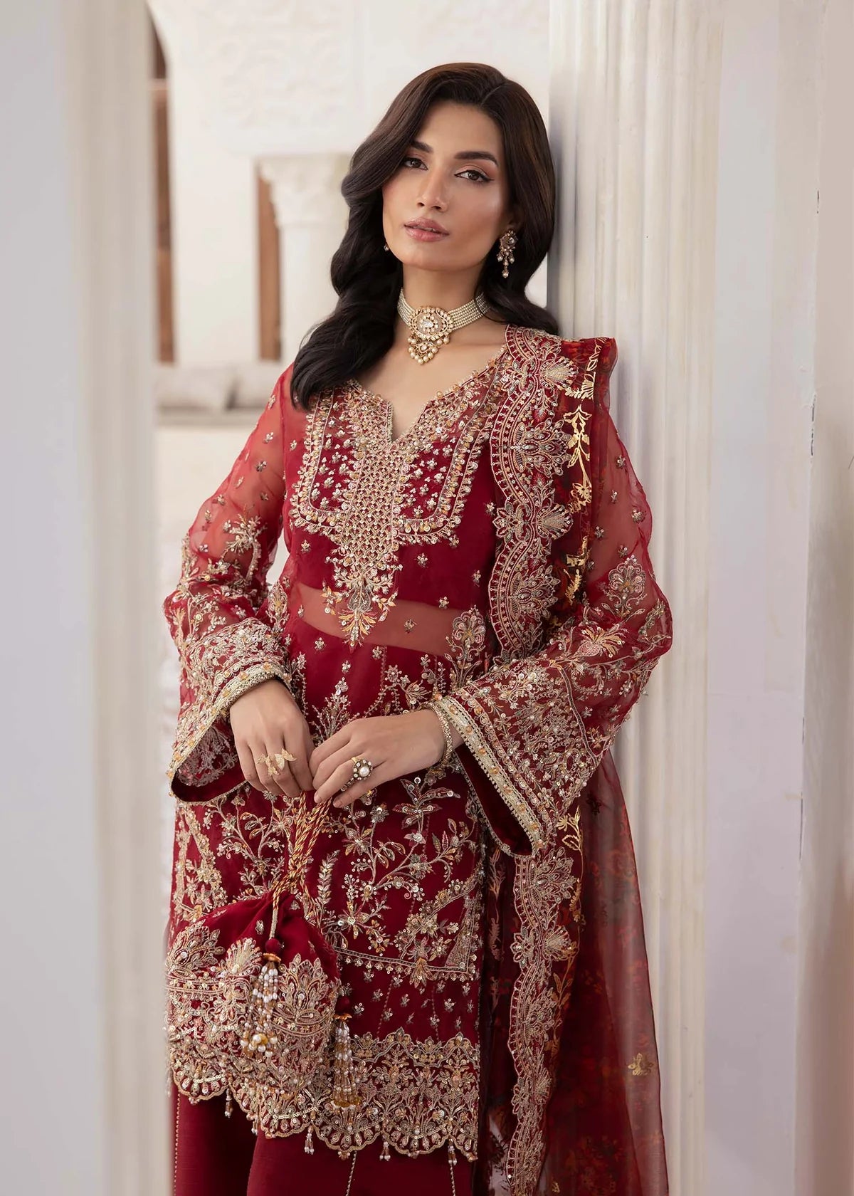 Model wearing deep red Zehrah outfit from Kanwal Malik with gold embroidery—Pakistani luxury pret perfect for weddings, shop in UK online.