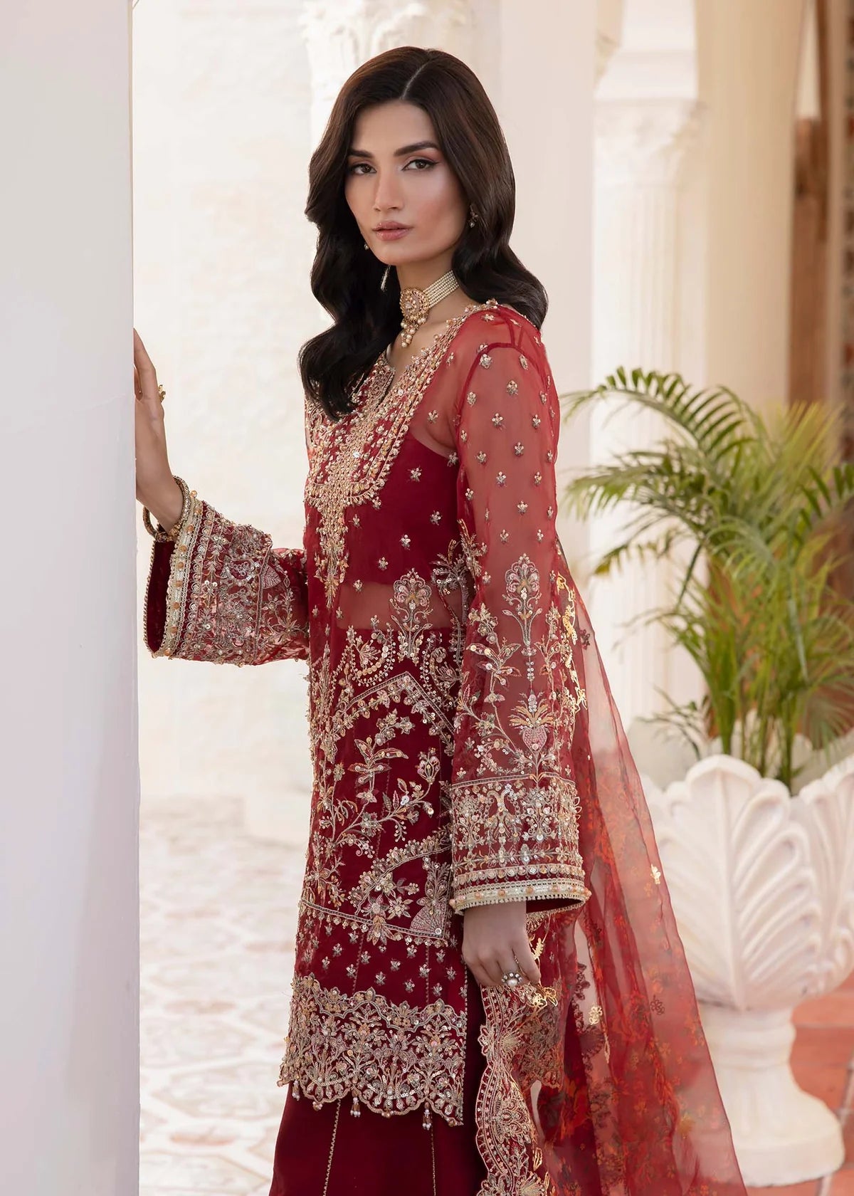 Model wearing deep red Zehrah outfit from Kanwal Malik with gold embroidery—Pakistani luxury pret perfect for weddings, shop in UK online.