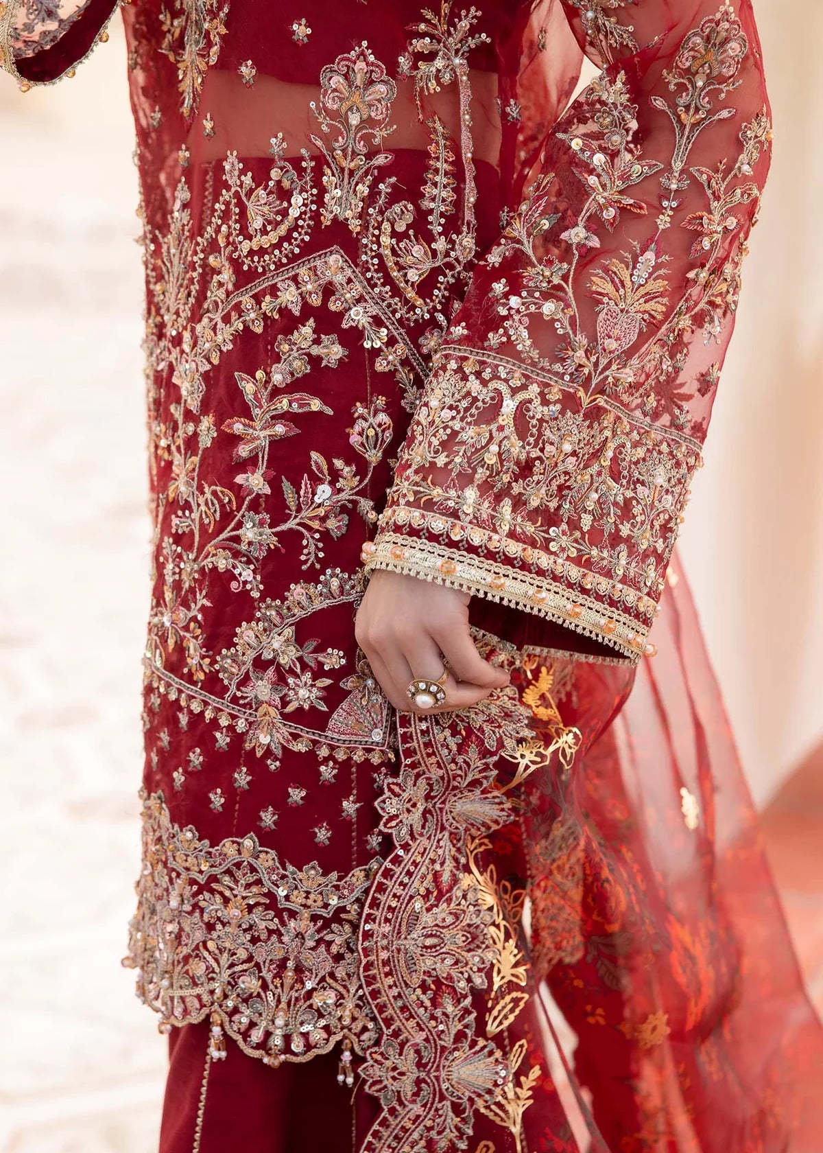Model wearing deep red Zehrah outfit from Kanwal Malik with gold embroidery—Pakistani luxury pret perfect for weddings, shop in UK online.