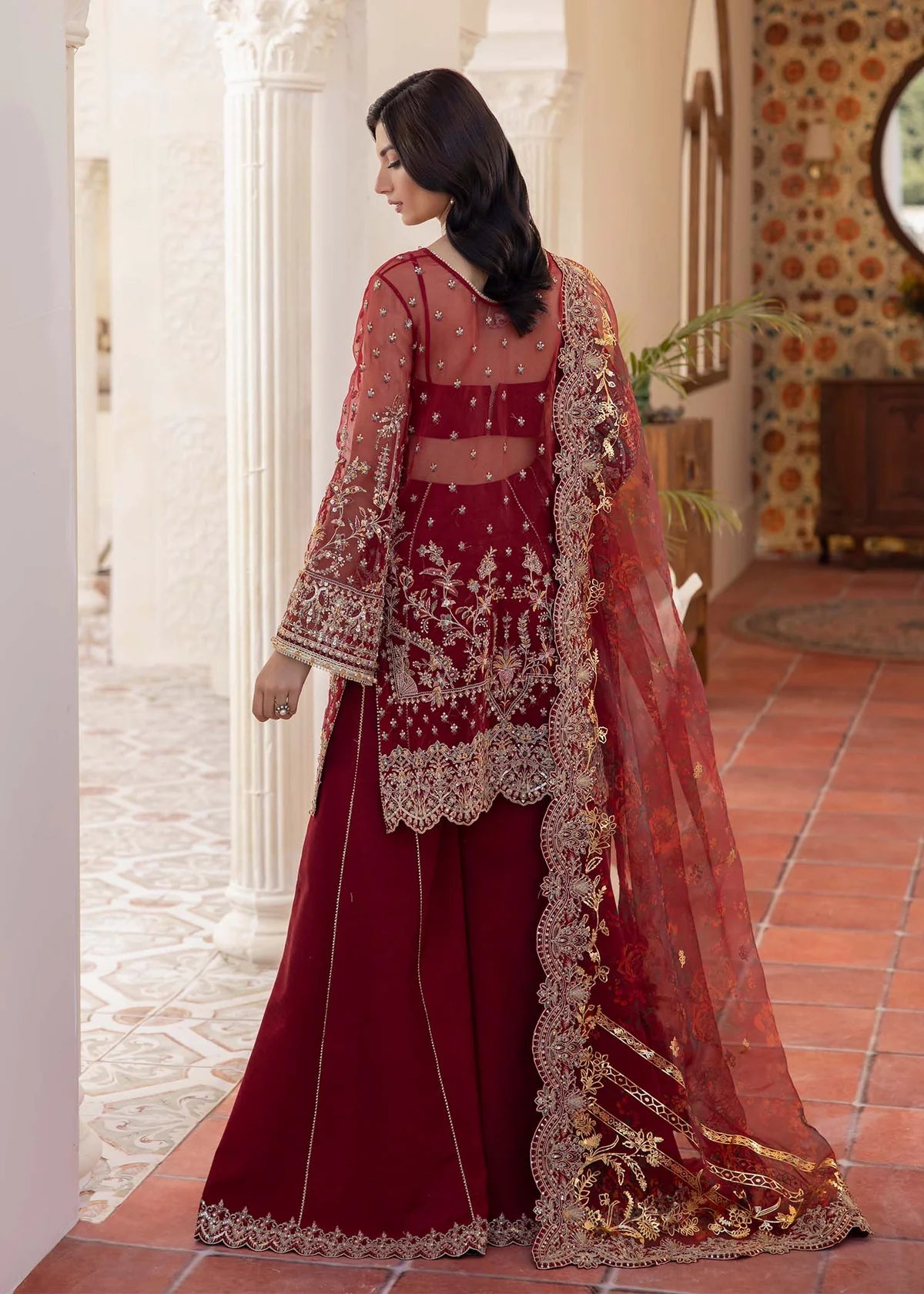 Model wearing deep red Zehrah outfit from Kanwal Malik with gold embroidery—Pakistani luxury pret perfect for weddings, shop in UK online.