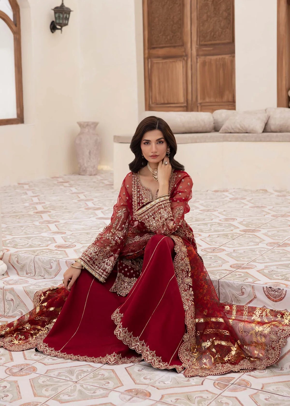 Model wearing deep red Zehrah outfit from Kanwal Malik with gold embroidery—Pakistani luxury pret perfect for weddings, shop in UK online.