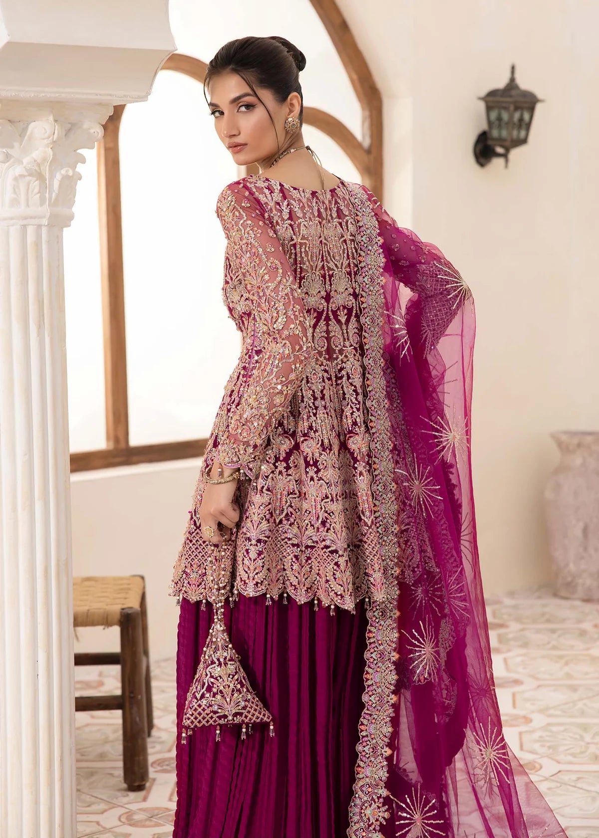 Model wearing deep magenta Kaira dress by Kanwal Malik, adorned with rich embroidery—Pakistani luxury pret available online in UK.