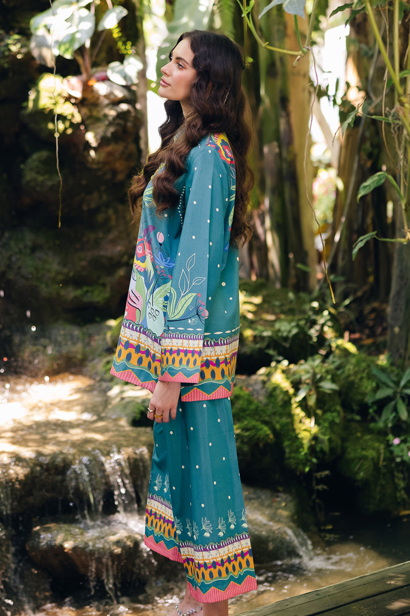 Model wearing OP-10 Liva, three-quarter view, a Pakistani designer outfit by Qalamkar, available online in the UK.