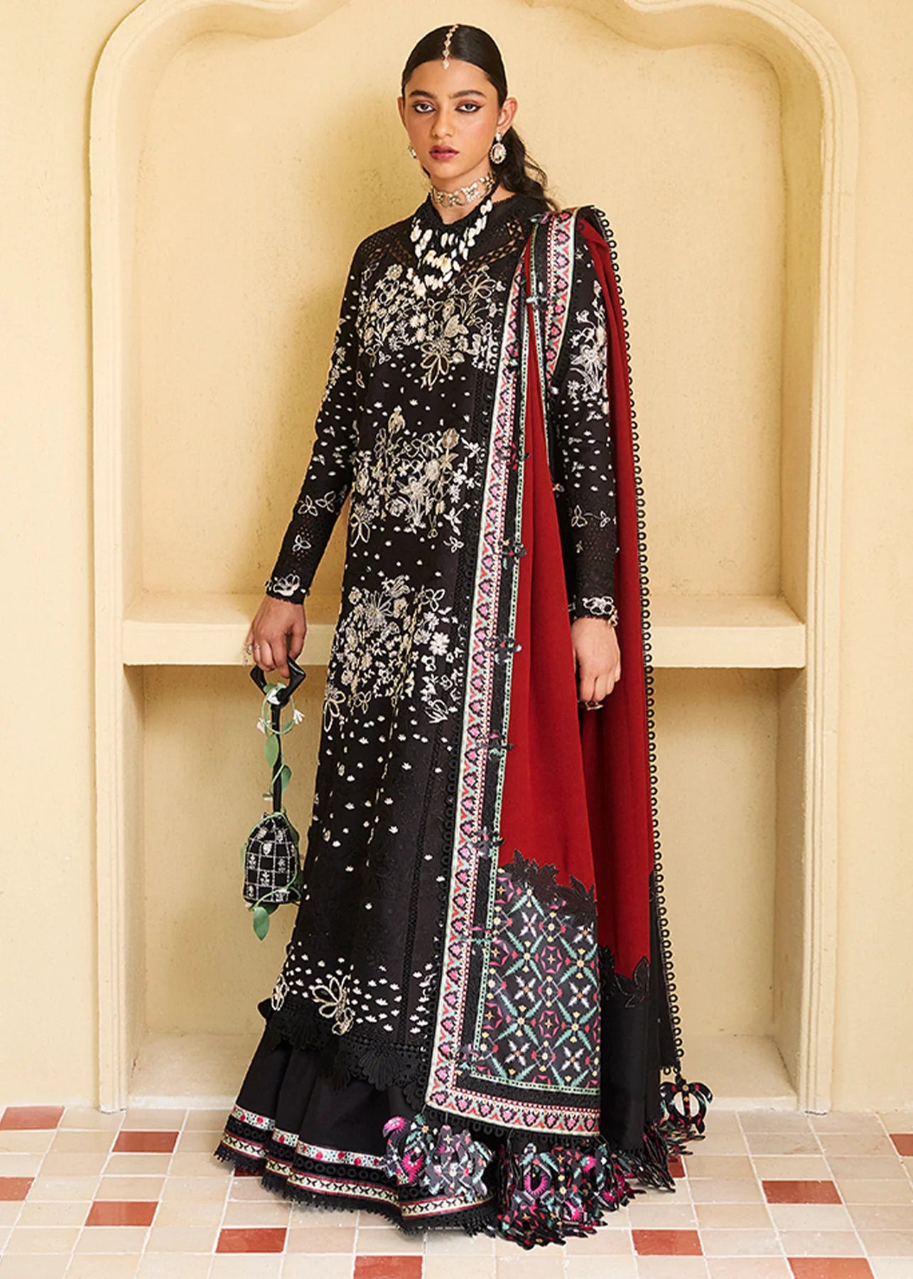 Model wearing black embroidered Kiran outfit from Suffuse Lawn Eid Edit '25, Pakistani luxury pret and Pakistani clothes online in UK.