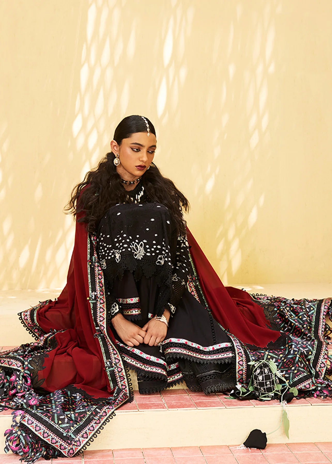 Model wearing black embroidered Kiran outfit from Suffuse Lawn Eid Edit '25, Pakistani luxury pret and Pakistani clothes online in UK.