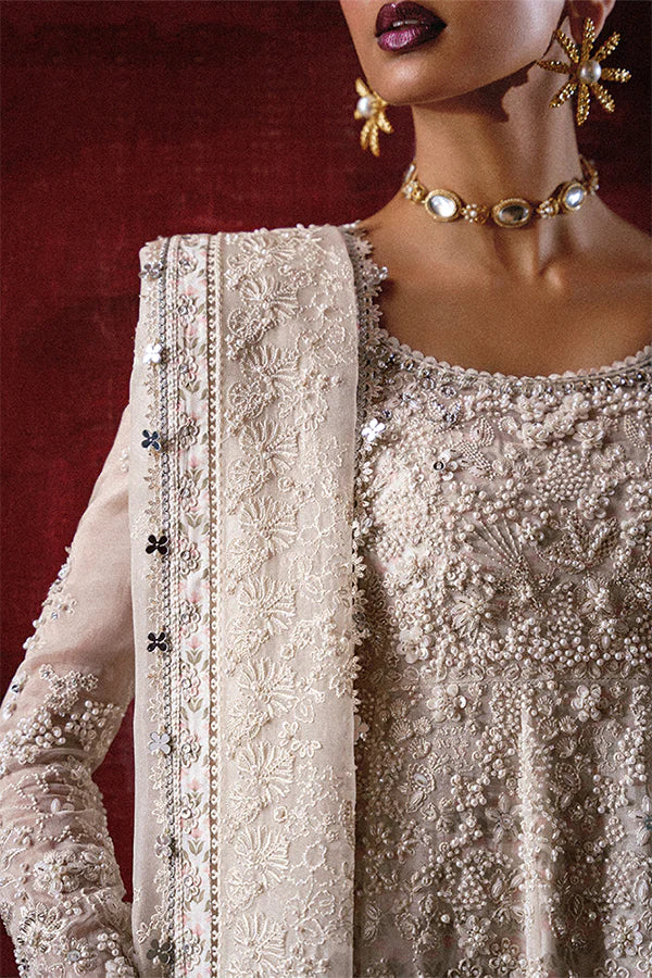 Model wearing ivory embellished gown from Suffuse Zahrell, Pakistani luxury pret, shop elegant Pakistani clothes online in UK
