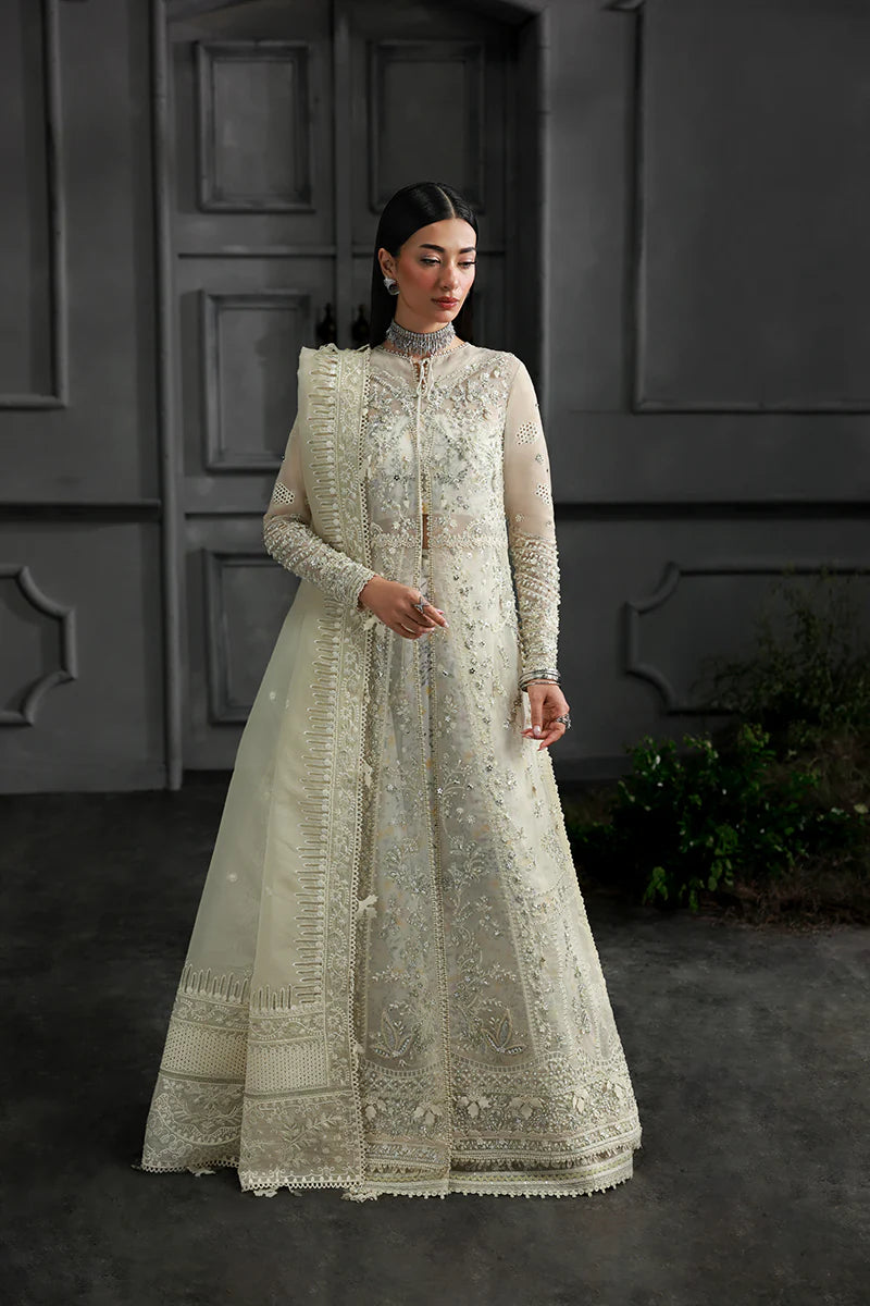 Model wearing MF-06 Ivara by Qalamkar in ivory hand-embroidered dress – Pakistani luxury pret perfect for festive wear, shop online in UK.