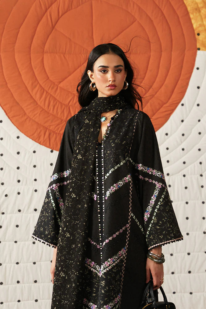 Model wearing Sazil by Suffuse in black with floral patterns and lace details – stylish Pakistani luxury pret outfit in UK.