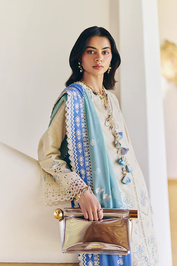 Model wearing off-white embroidered dress with blue printed dupatta from Suffuse Casual Pret 2025 Danae. Pakistani luxury pret in UK.