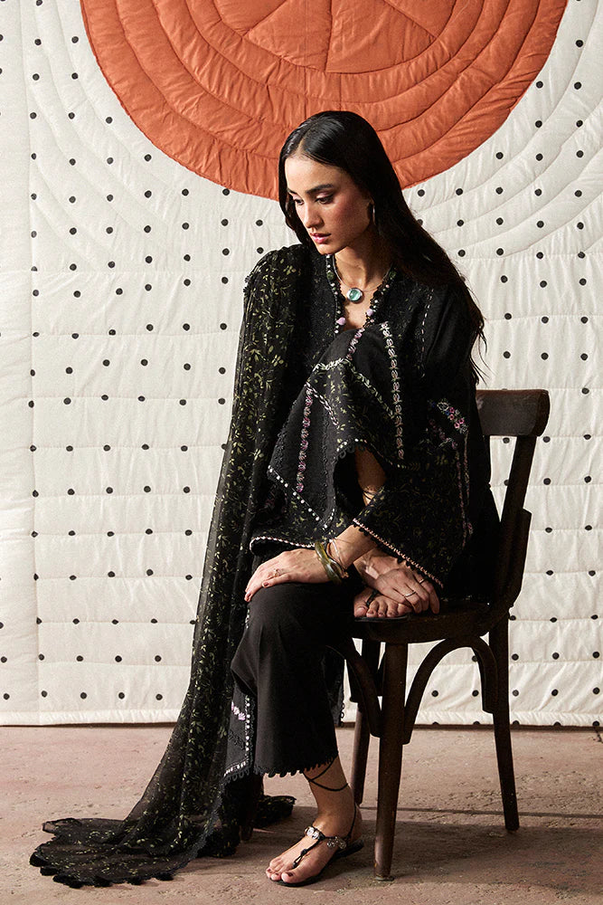 Model wearing Sazil by Suffuse in black with floral patterns and lace details – stylish Pakistani luxury pret outfit in UK.