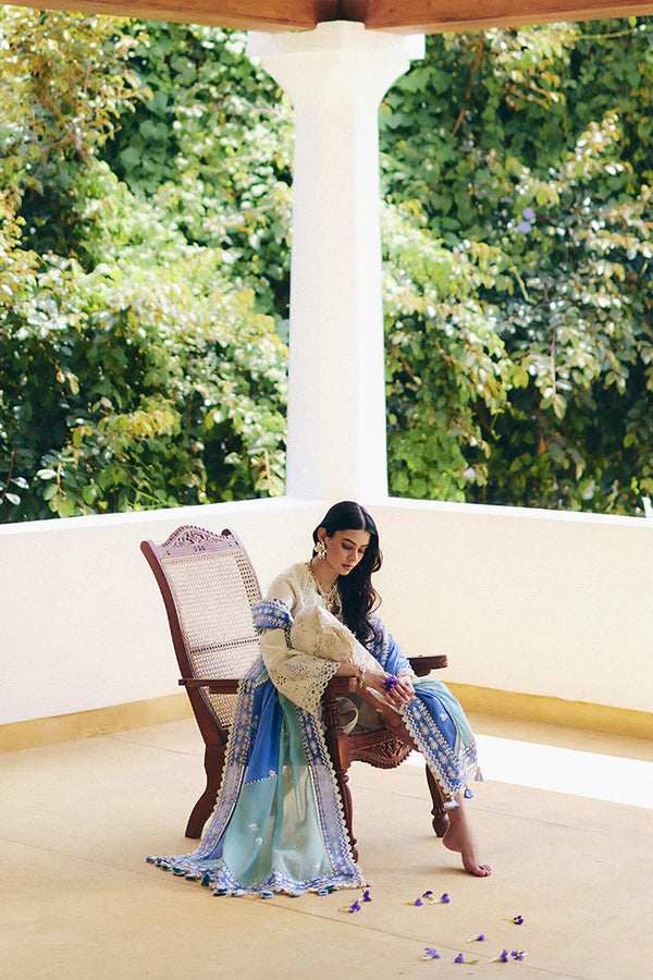 Model wearing off-white embroidered dress with blue printed dupatta from Suffuse Casual Pret 2025 Danae. Pakistani luxury pret in UK.