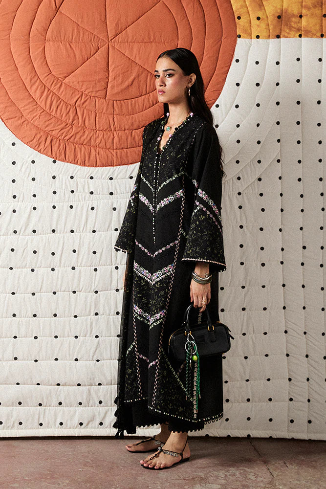Model wearing Sazil by Suffuse in black with floral patterns and lace details – stylish Pakistani luxury pret outfit in UK.