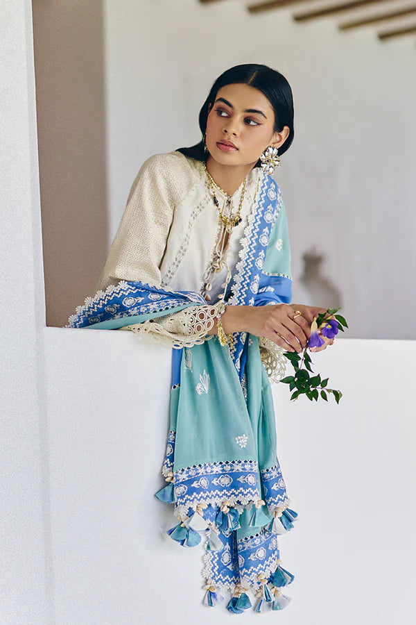 Model wearing off-white embroidered dress with blue printed dupatta from Suffuse Casual Pret 2025 Danae. Pakistani luxury pret in UK.