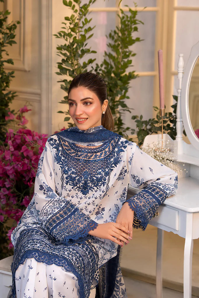 Model wearing Sobia Nazir Vital 2025 Design 10B in white and navy with intricate blue embroidery. Shop Pakistani luxury pret in UK.