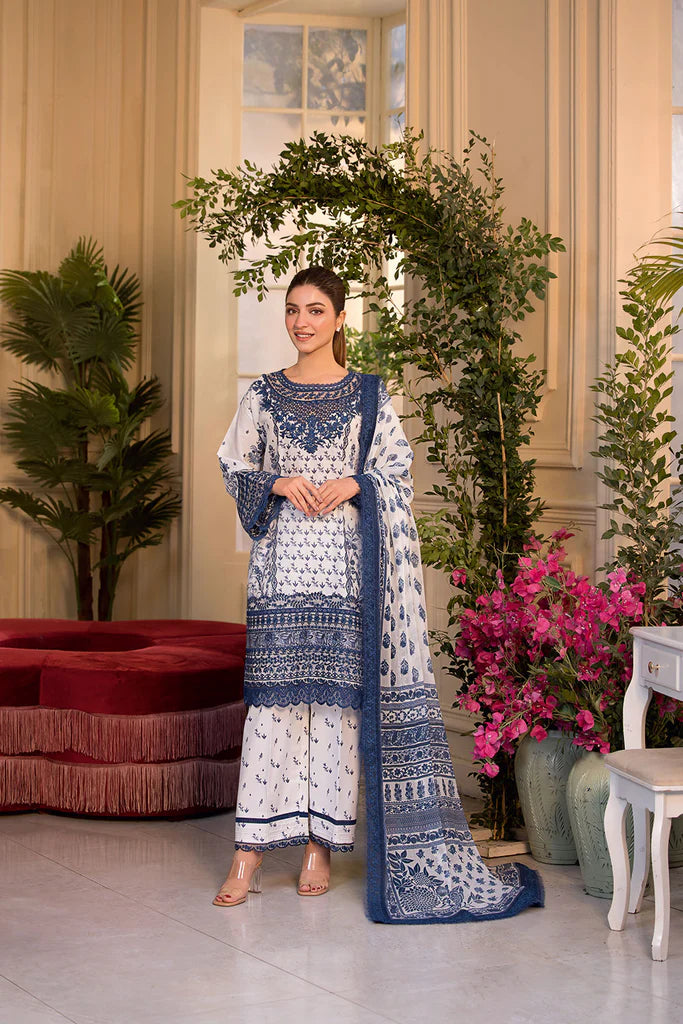 Model wearing Sobia Nazir Vital 2025 Design 10B in white and navy with intricate blue embroidery. Shop Pakistani luxury pret in UK.