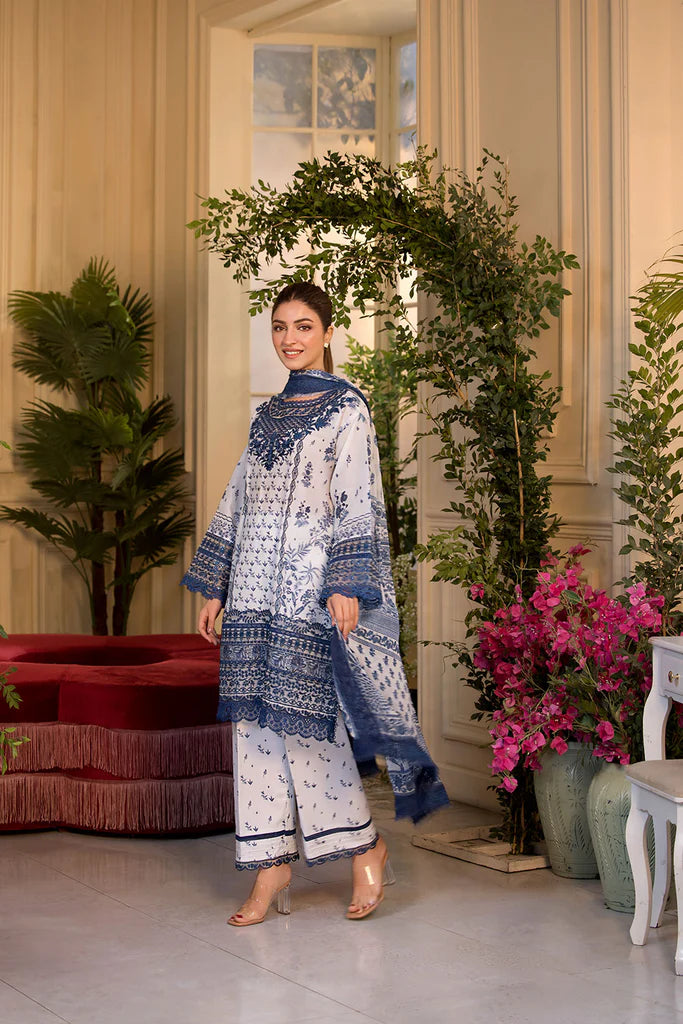 Model wearing Sobia Nazir Vital 2025 Design 10B in white and navy with intricate blue embroidery. Shop Pakistani luxury pret in UK.