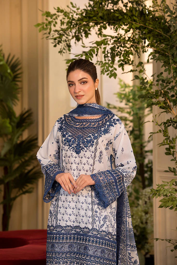Model wearing Sobia Nazir Vital 2025 Design 10B in white and navy with intricate blue embroidery. Shop Pakistani luxury pret in UK.