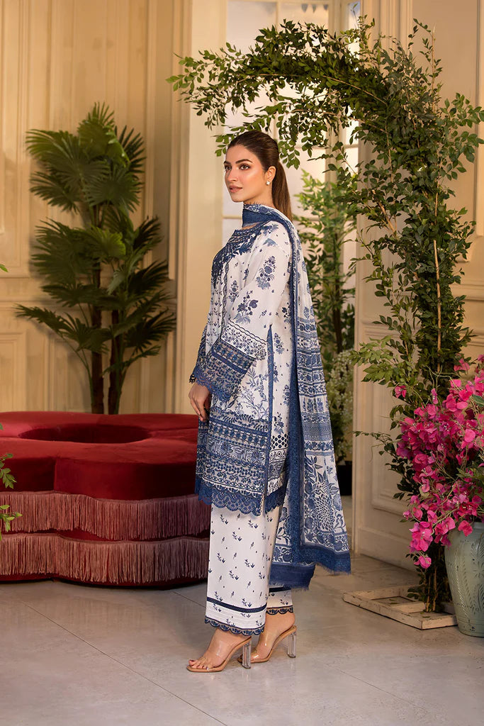 Model wearing Sobia Nazir Vital 2025 Design 10B in white and navy with intricate blue embroidery. Shop Pakistani luxury pret in UK.