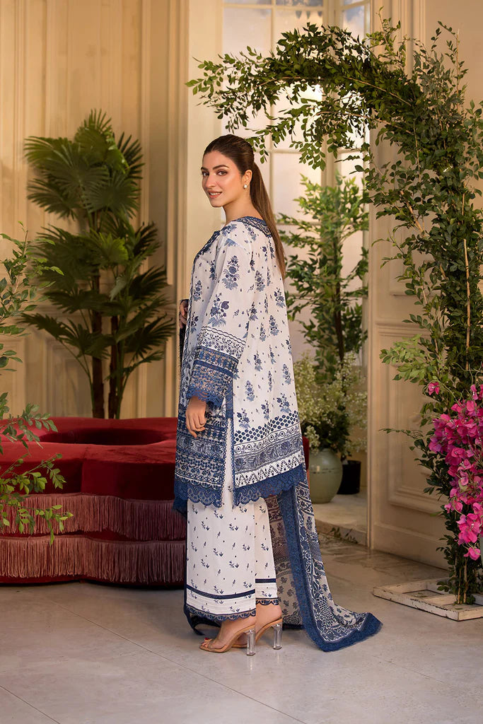 Model wearing Sobia Nazir Vital 2025 Design 10B in white and navy with intricate blue embroidery. Shop Pakistani luxury pret in UK.