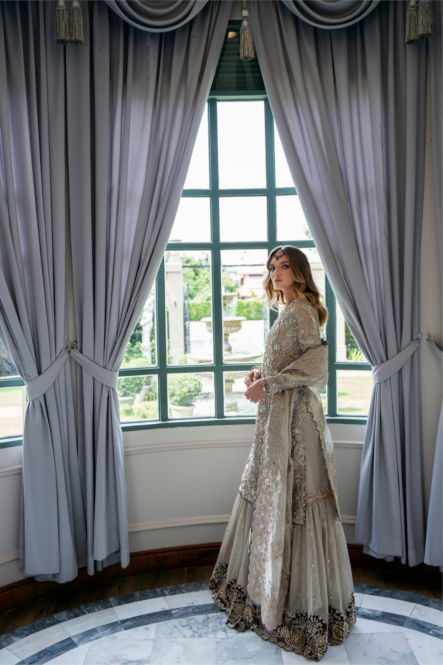 Model wearing Arya from Mysie by Tahira in beige with intricate embellishments, perfect for Pakistani luxury pret in the UK.