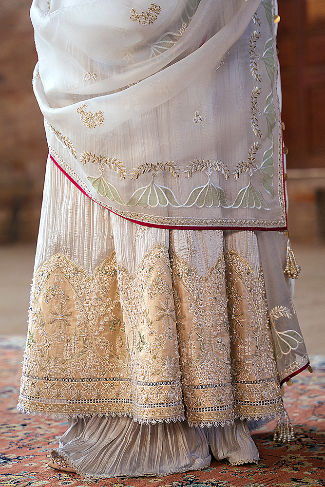 Model wearing NEVE, three-quarter view, a Pakistani designer outfit by Suffuse, available online in the UK.