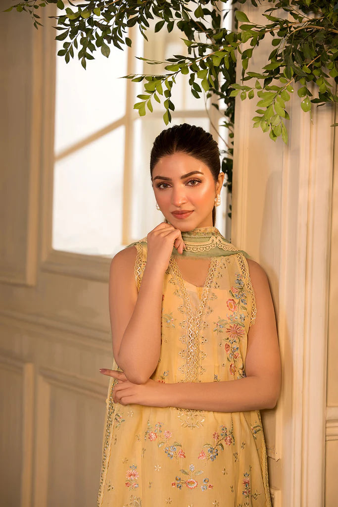 Model wearing Sobia Nazir Vital 2025 Design 1B in mustard yellow with embroidered detailing. Shop Pakistani luxury pret online in UK.