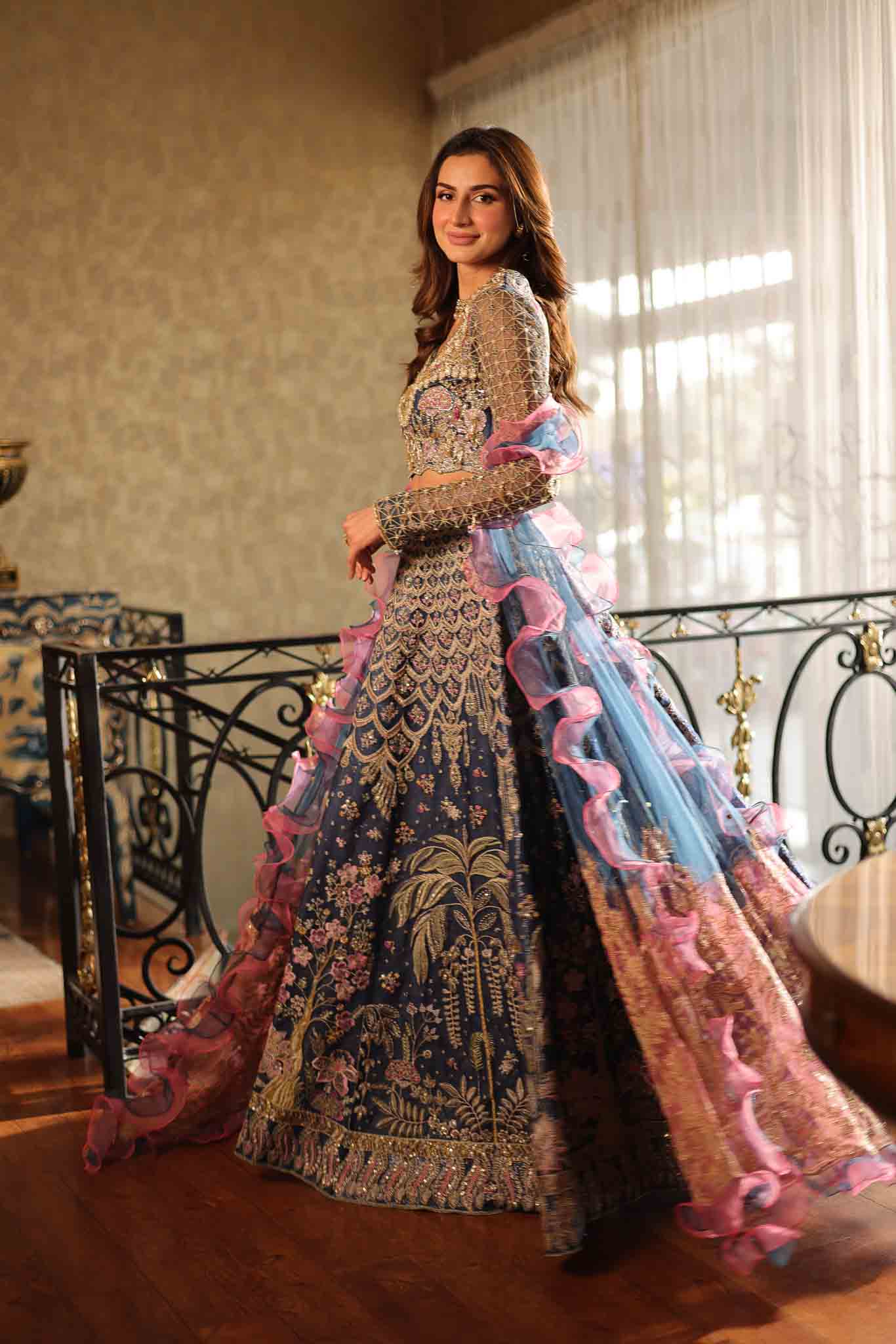 Model wearing blue and pink embellished lehenga choli Stella from Mysie By Tahira Wedding Edits '25, Pakistani luxury pret online in UK.