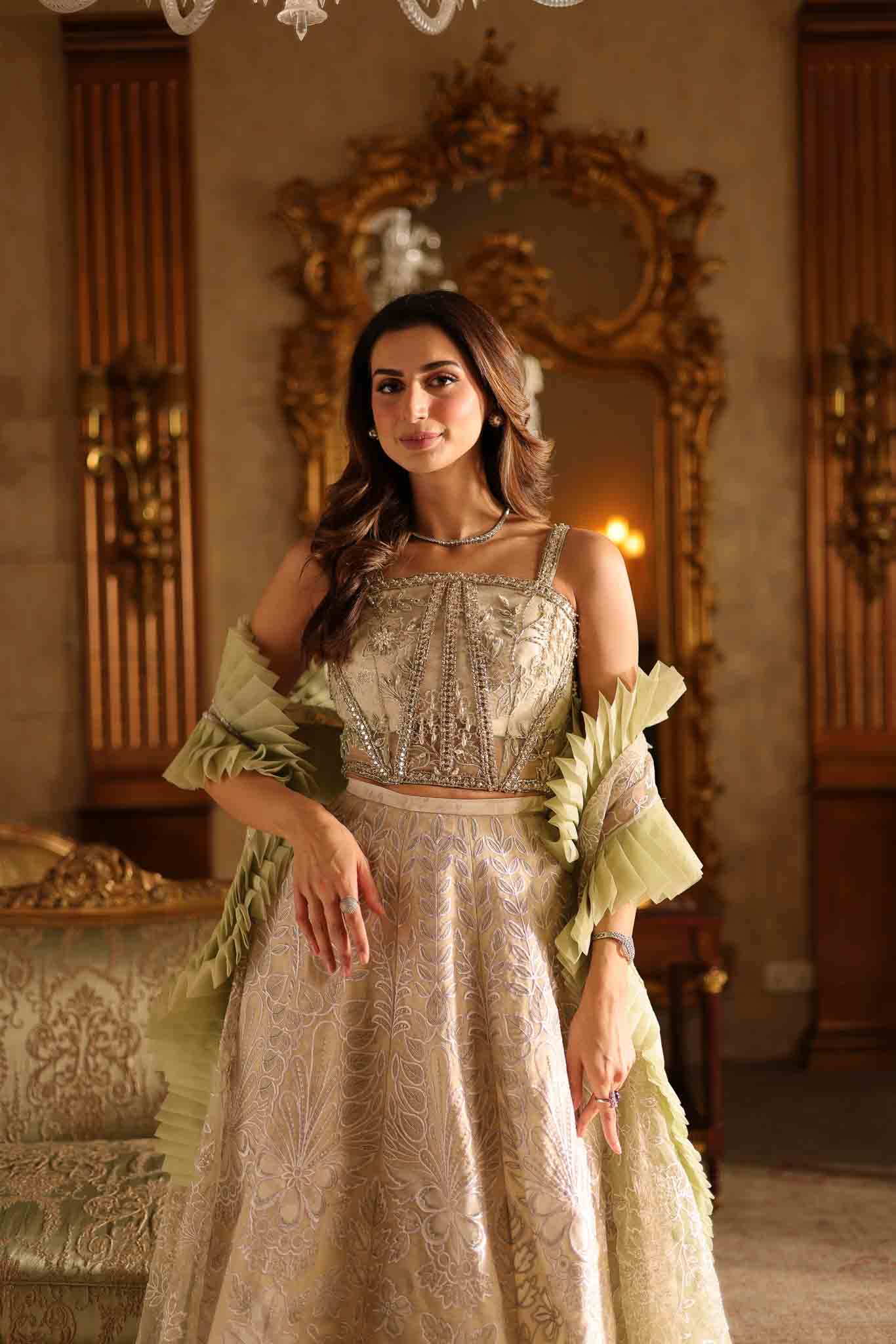 Model wearing beige and pastel green floor-length flared dress with ruffle accents from Mysie By Tahira's Esmera, Pakistani clothes online in UK.