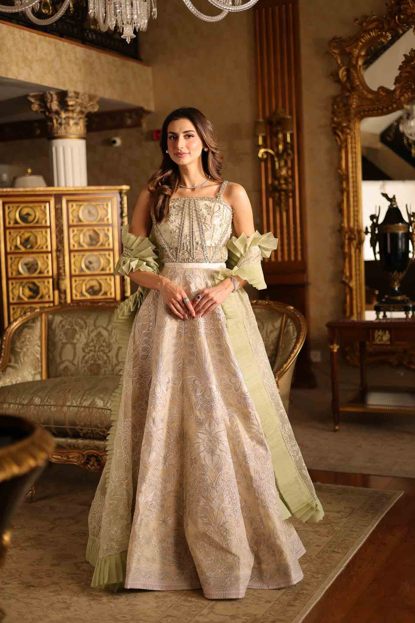 Model wearing beige and pastel green floor-length flared dress with ruffle accents from Mysie By Tahira's Esmera, Pakistani clothes online in UK.