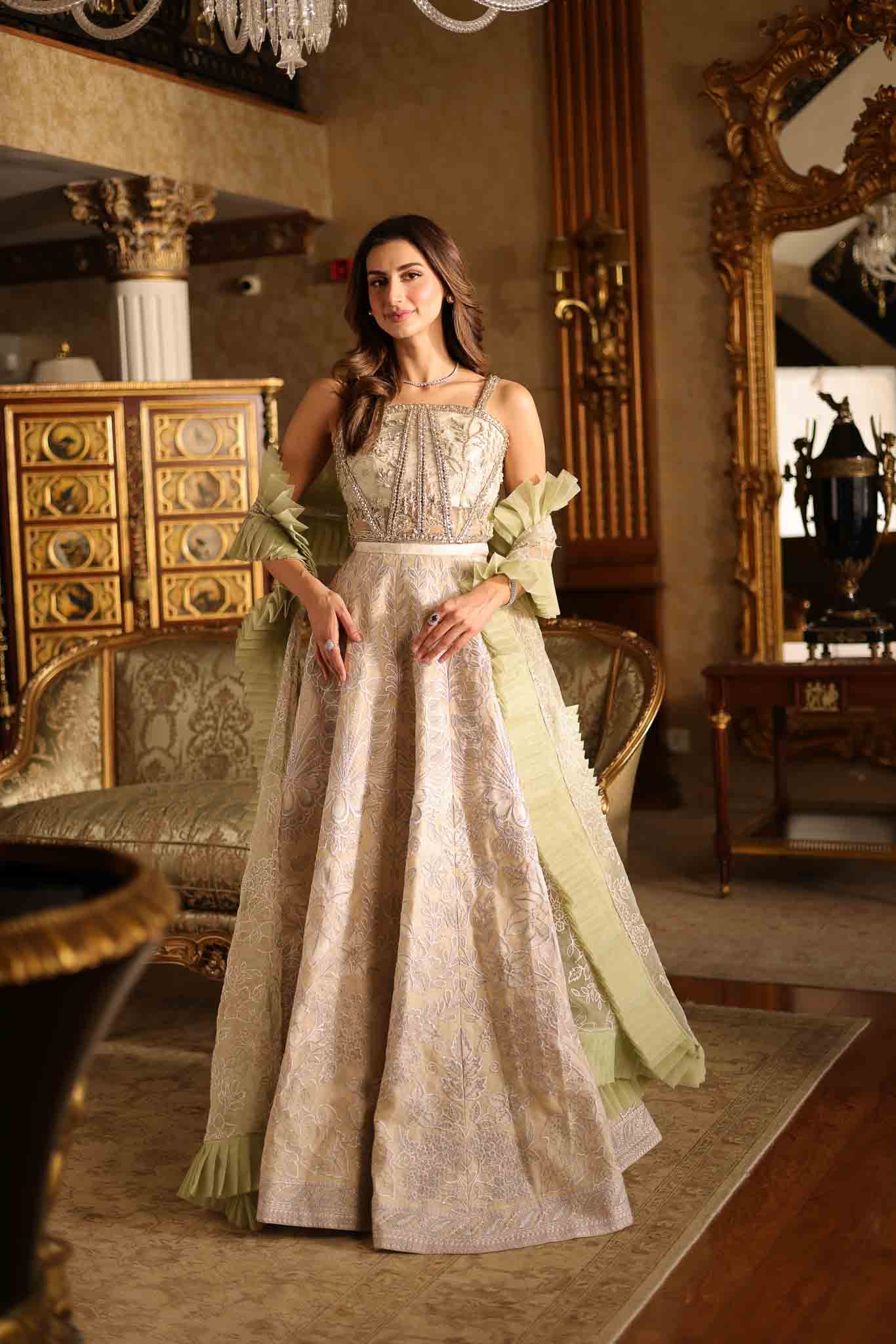 Model wearing beige and pastel green floor-length flared dress with ruffle accents from Mysie By Tahira's Esmera, Pakistani clothes online in UK.