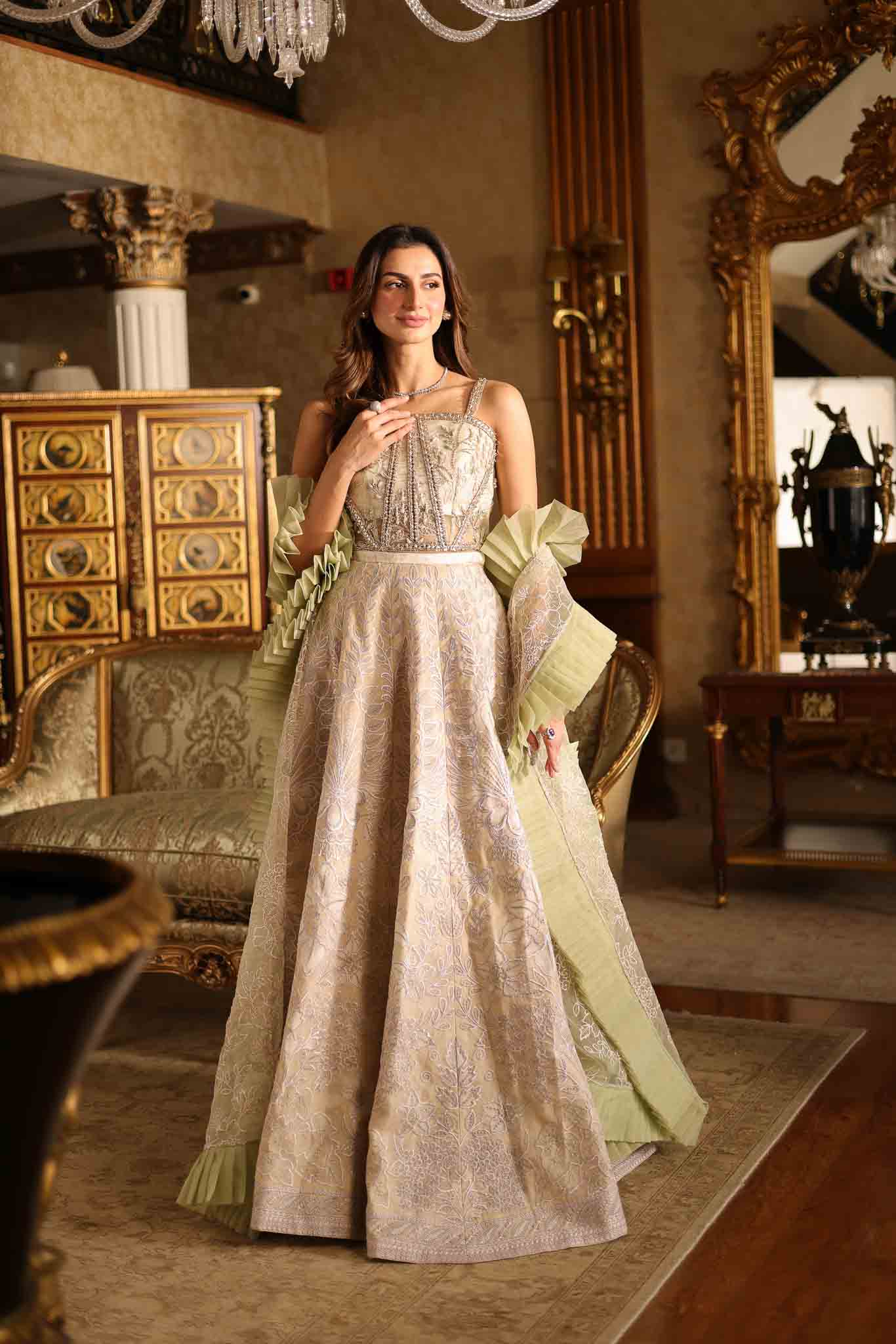 Model wearing beige and pastel green floor-length flared dress with ruffle accents from Mysie By Tahira's Esmera, Pakistani clothes online in UK.