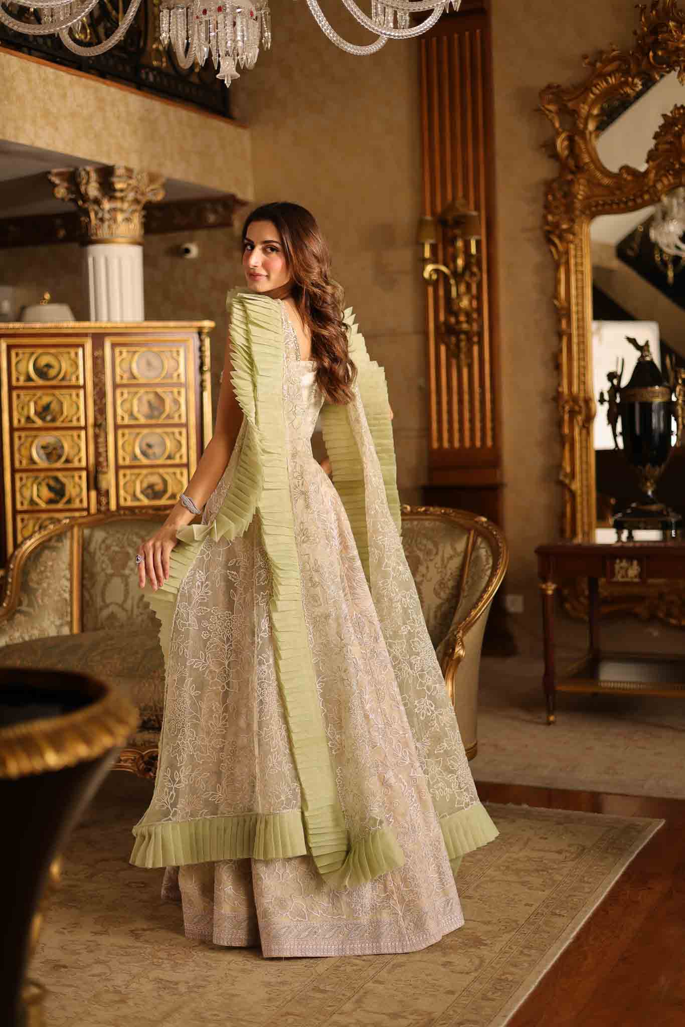 Model wearing beige and pastel green floor-length flared dress with ruffle accents from Mysie By Tahira's Esmera, Pakistani clothes online in UK.
