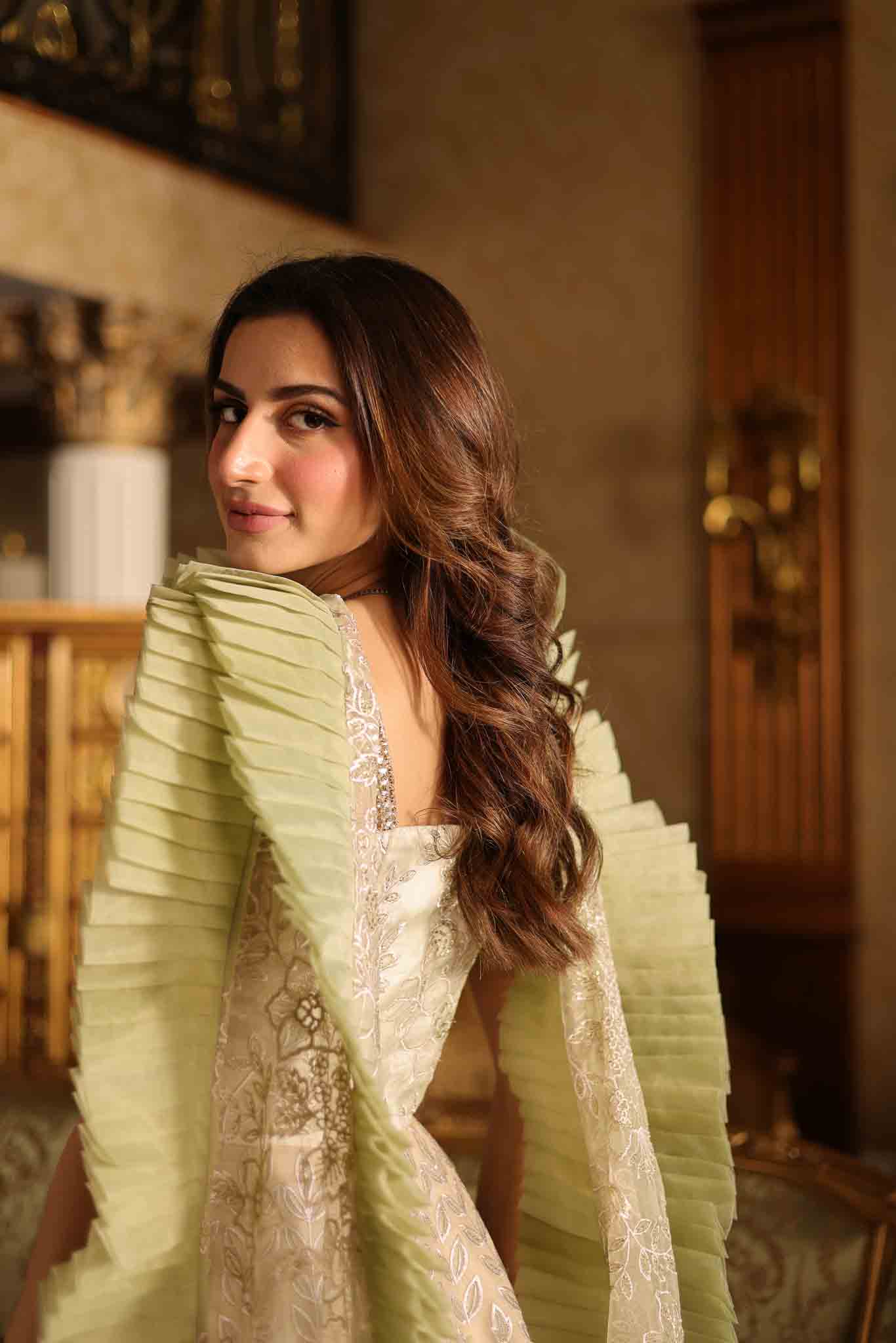 Model wearing beige and pastel green floor-length flared dress with ruffle accents from Mysie By Tahira's Esmera, Pakistani clothes online in UK.