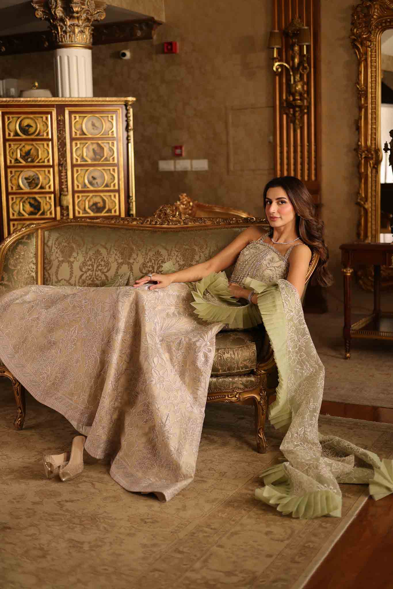 Model wearing beige and pastel green floor-length flared dress with ruffle accents from Mysie By Tahira's Esmera, Pakistani clothes online in UK.