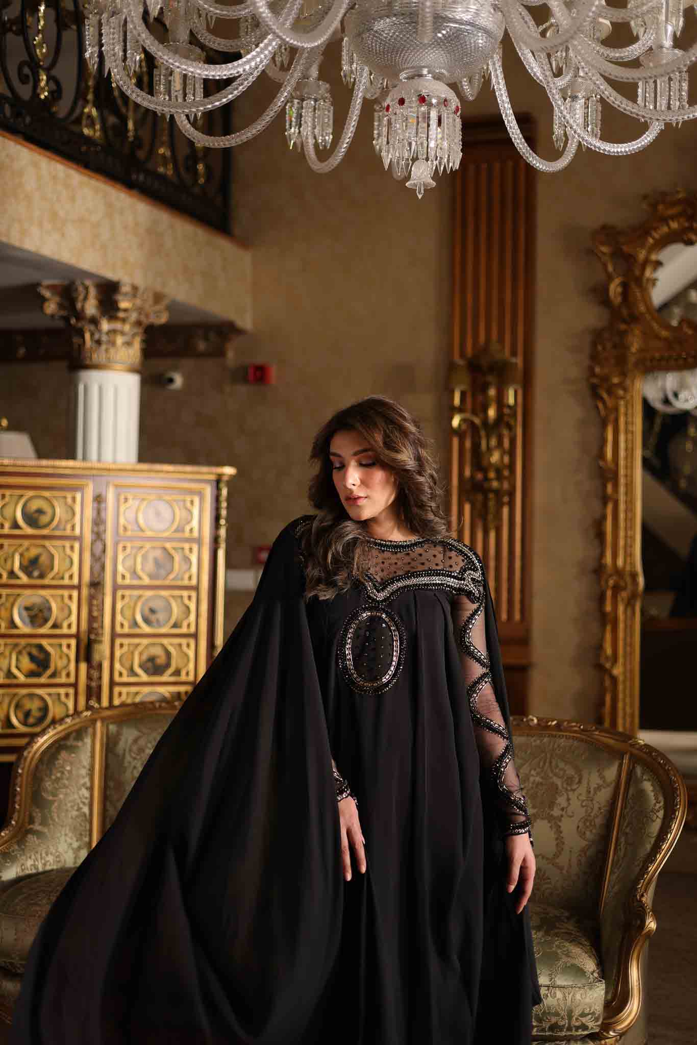 Model wearing black embellished kaftan-style dress with sheer detailing from Mysie By Tahira's Izara, Pakistani clothes online in UK.