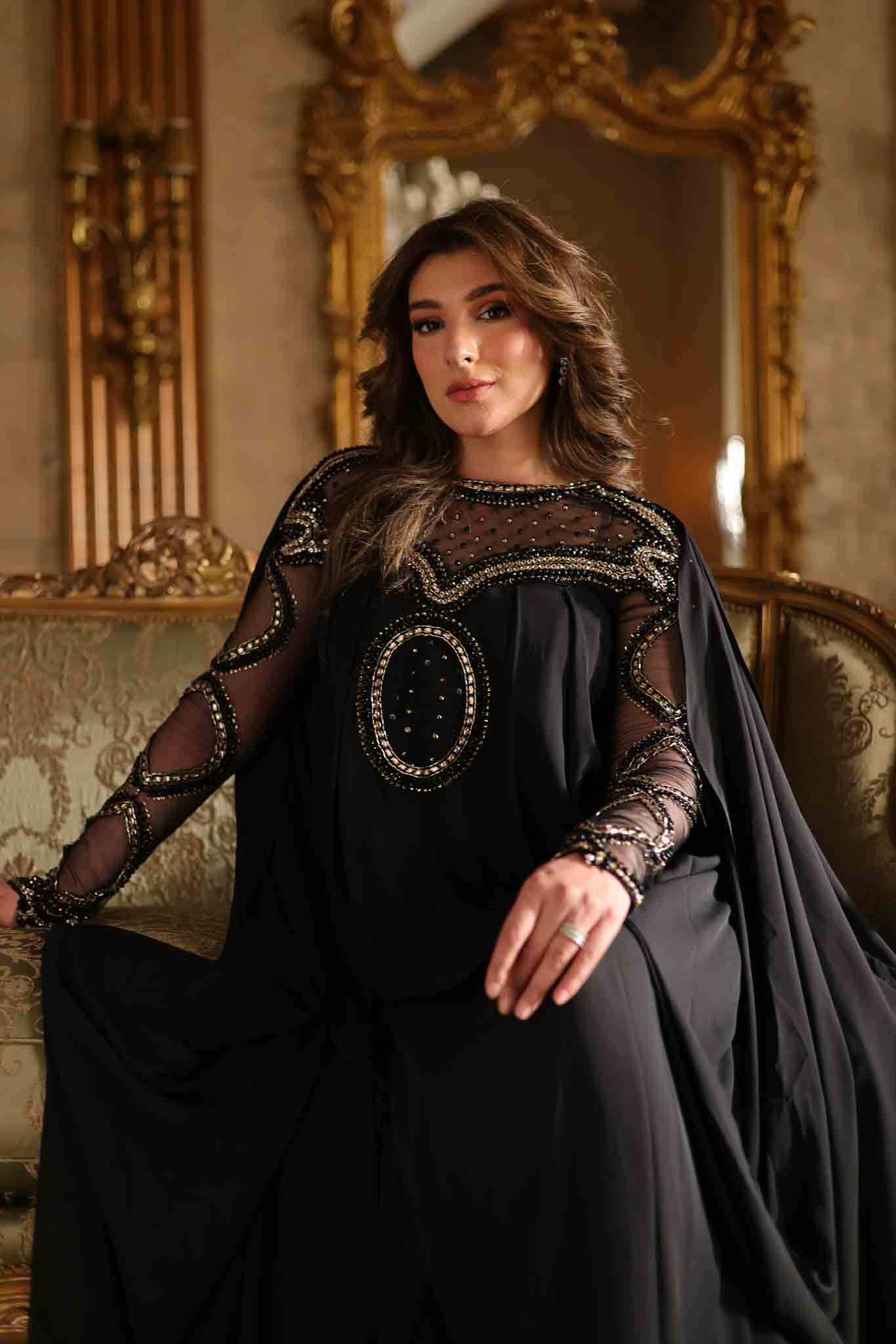 Model wearing black embellished kaftan-style dress with sheer detailing from Mysie By Tahira's Izara, Pakistani clothes online in UK.