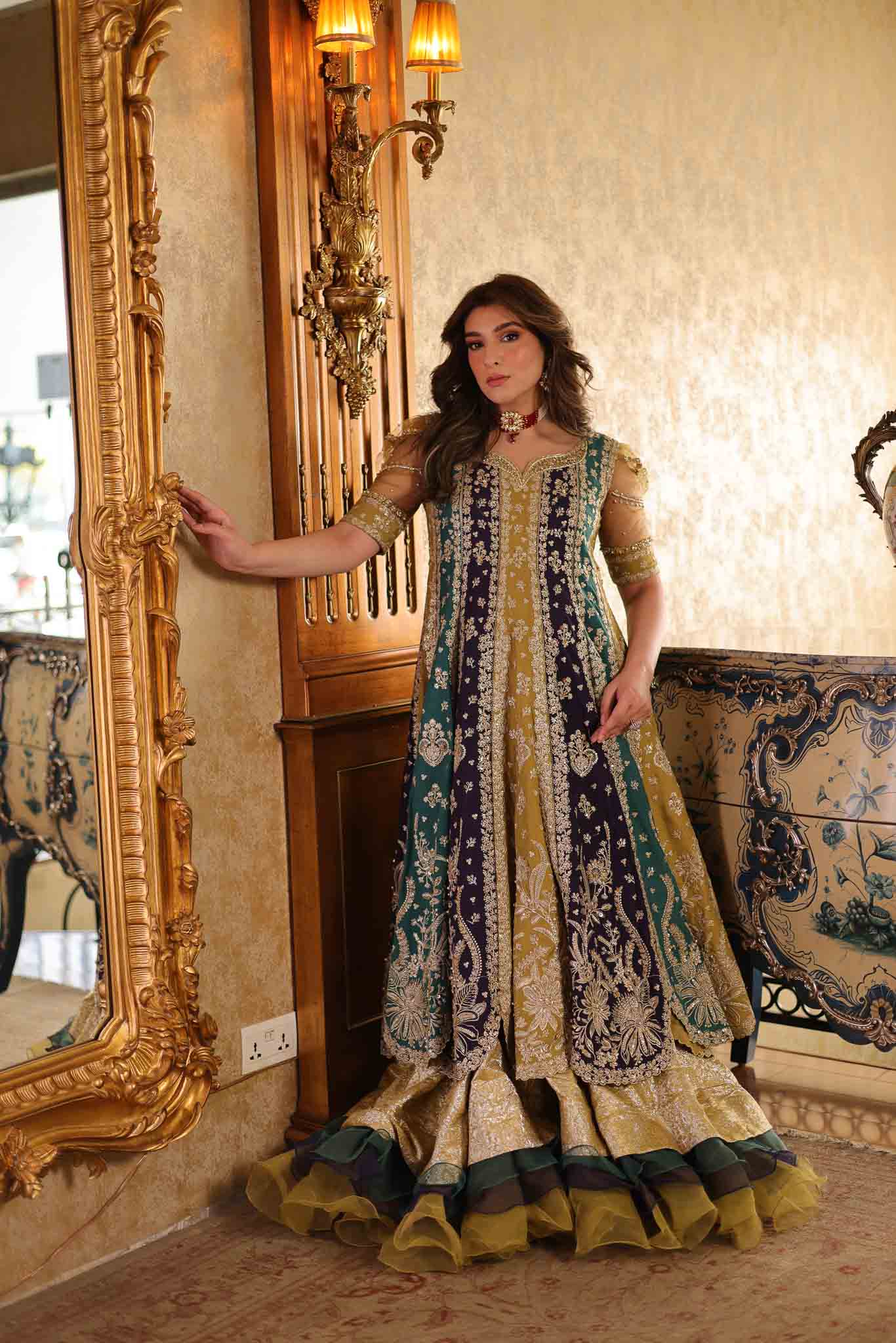Model wearing multicolor panelled pishwas with mustard frill lehenga from Mysie By Tahira's Nazneen, Pakistani Luxury pret in UK.