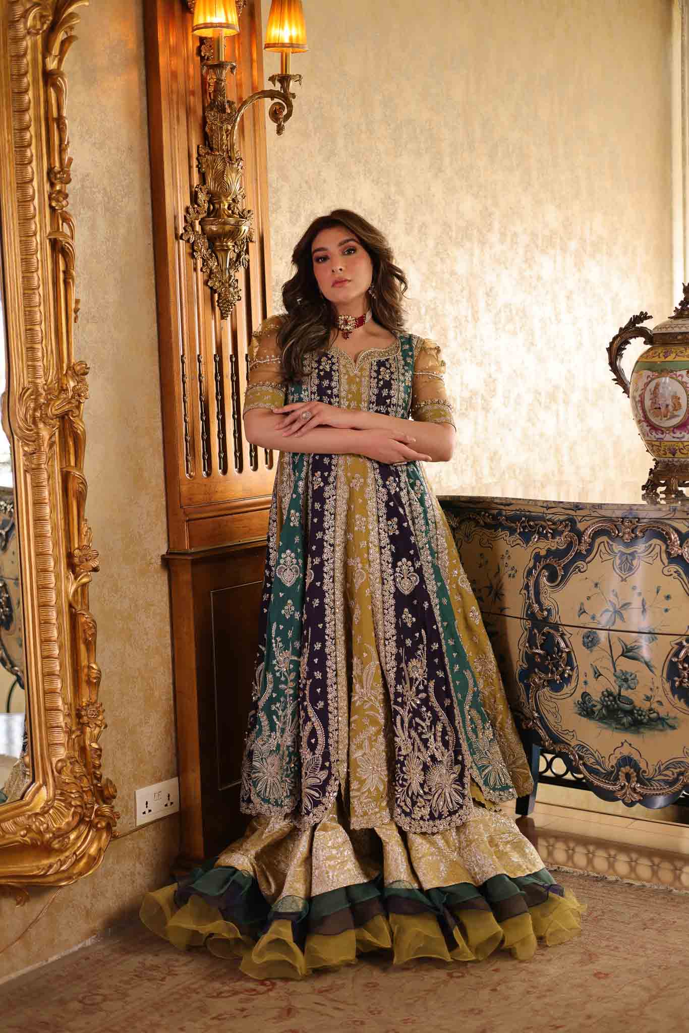 Model wearing multicolor panelled pishwas with mustard frill lehenga from Mysie By Tahira's Nazneen, Pakistani Luxury pret in UK.