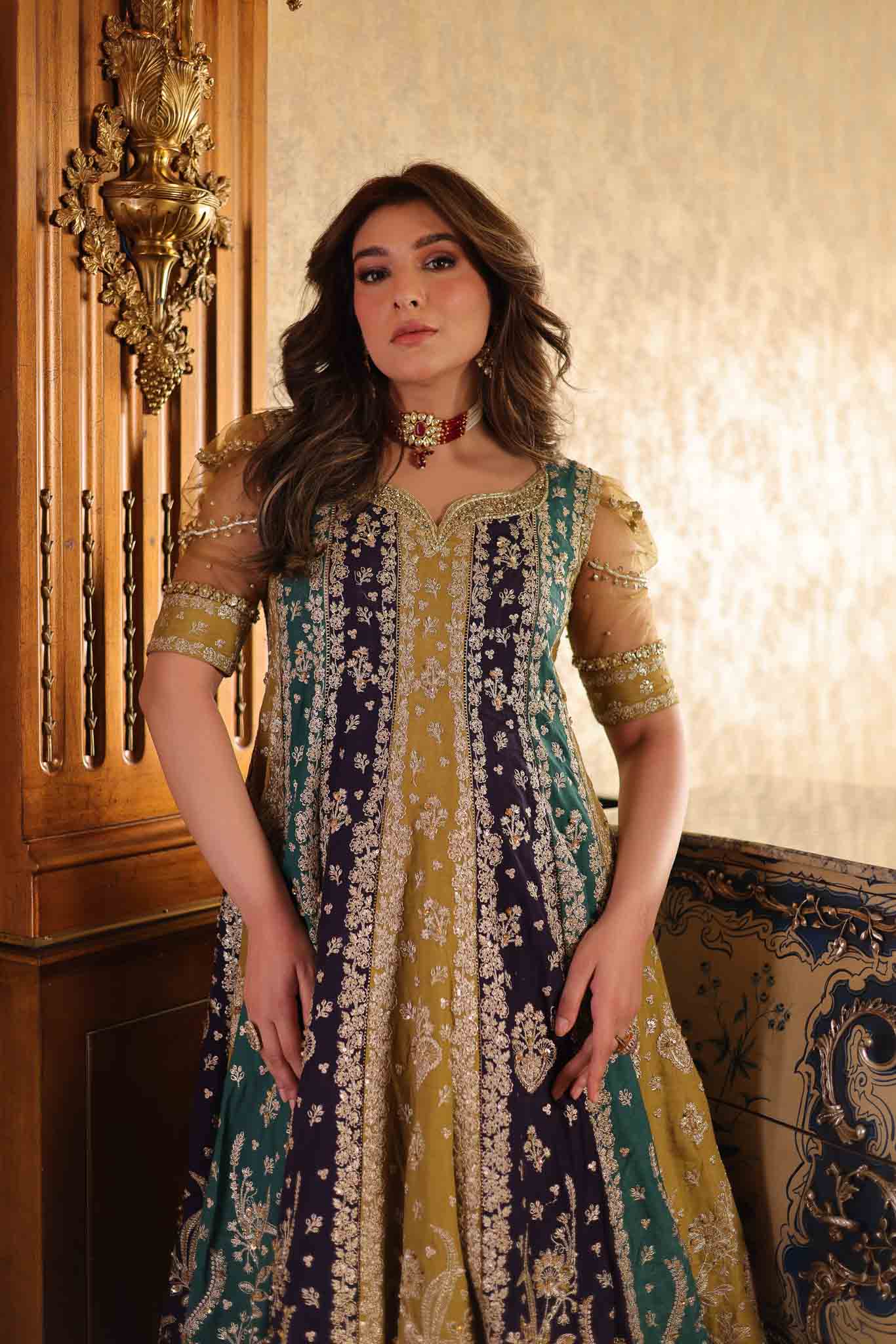 Model wearing multicolor panelled pishwas with mustard frill lehenga from Mysie By Tahira's Nazneen, Pakistani Luxury pret in UK.