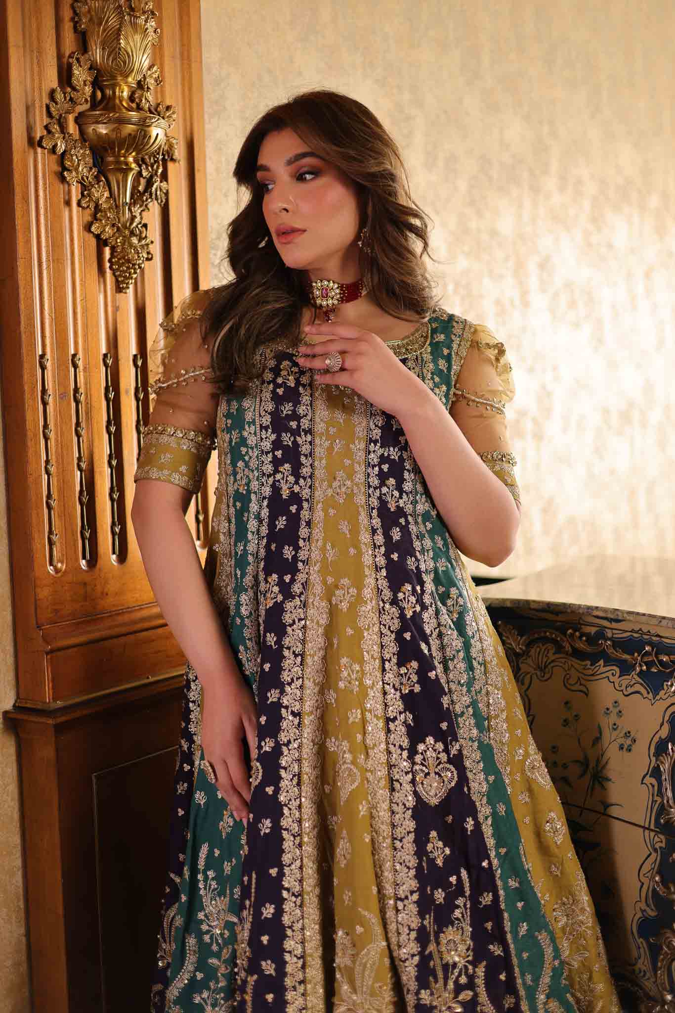 Model wearing multicolor panelled pishwas with mustard frill lehenga from Mysie By Tahira's Nazneen, Pakistani Luxury pret in UK.