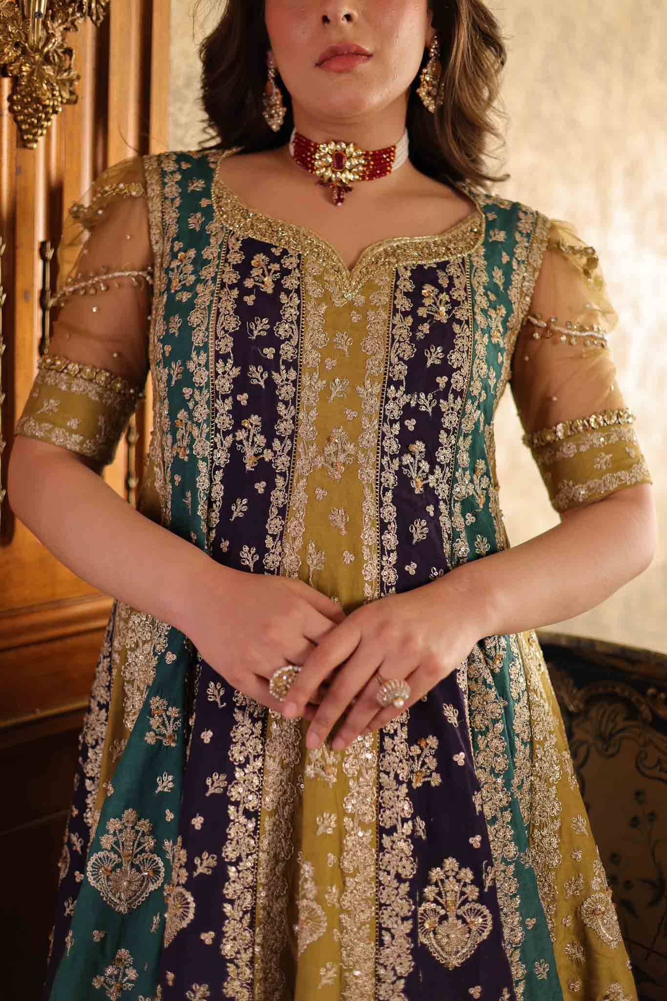 Model wearing multicolor panelled pishwas with mustard frill lehenga from Mysie By Tahira's Nazneen, Pakistani Luxury pret in UK.