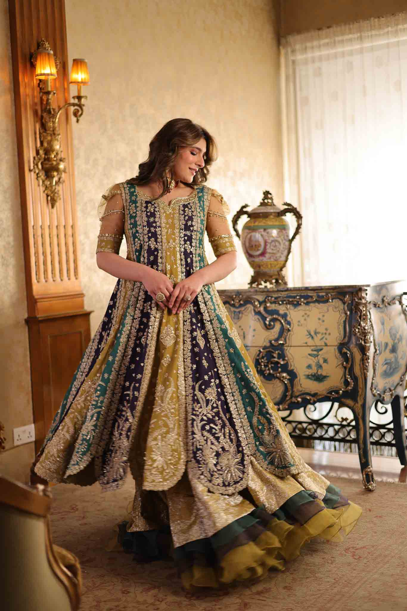 Model wearing multicolor panelled pishwas with mustard frill lehenga from Mysie By Tahira's Nazneen, Pakistani Luxury pret in UK.