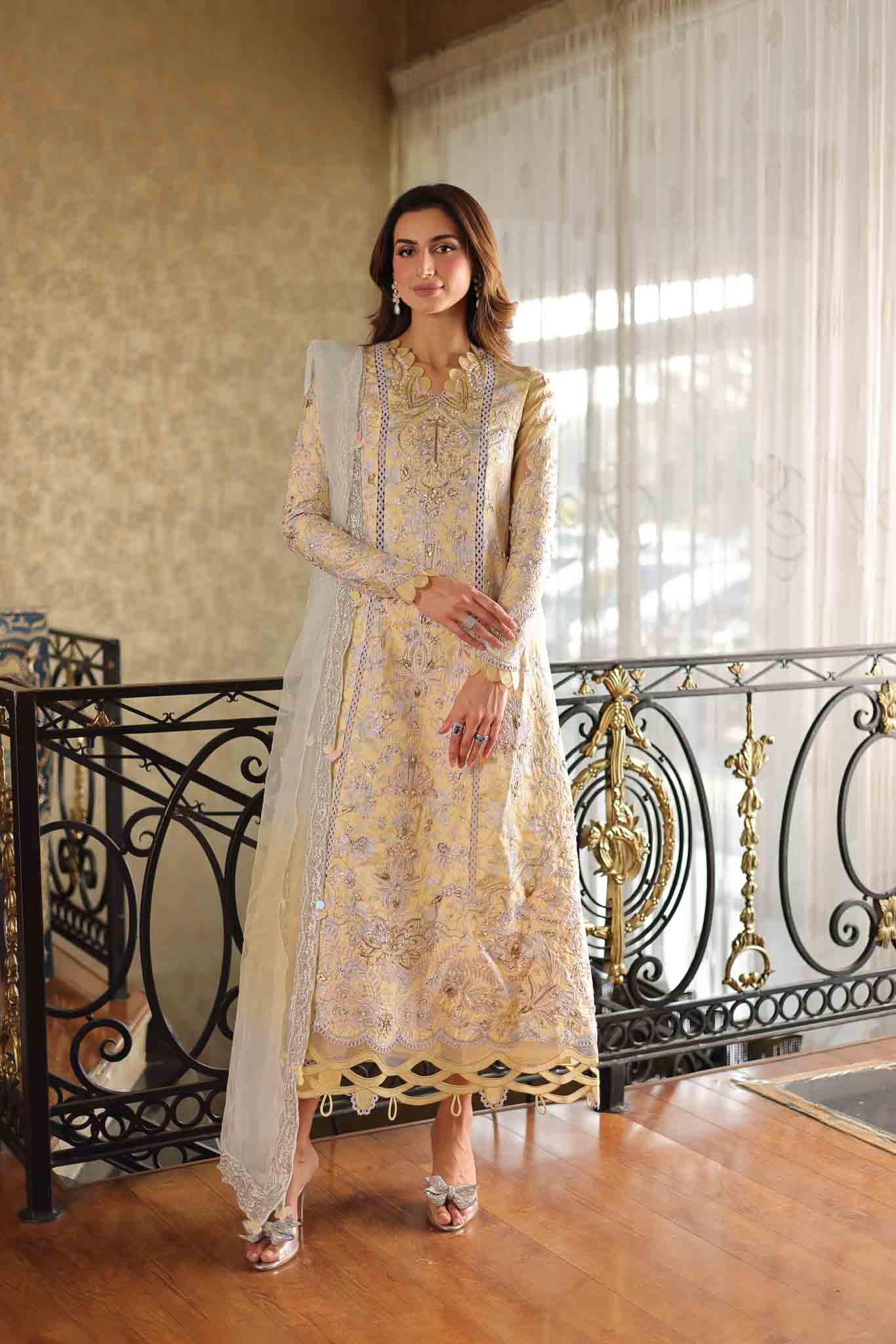 Model wearing pastel yellow embroidered long shirt with ivory dupatta from Mysie By Tahira's Tulip, Pakistani Luxury pret in UK.