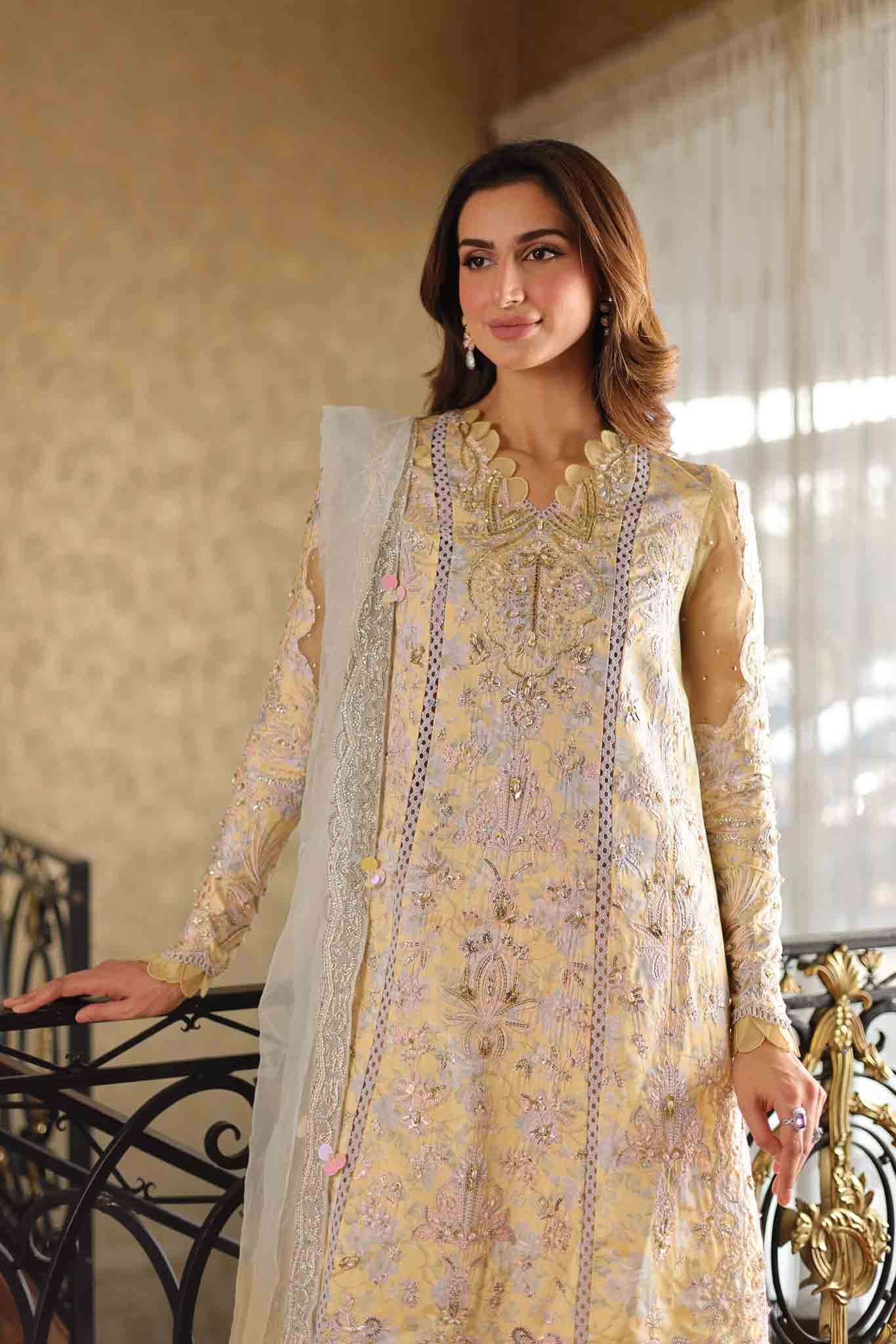Model wearing pastel yellow embroidered long shirt with ivory dupatta from Mysie By Tahira's Tulip, Pakistani Luxury pret in UK.
