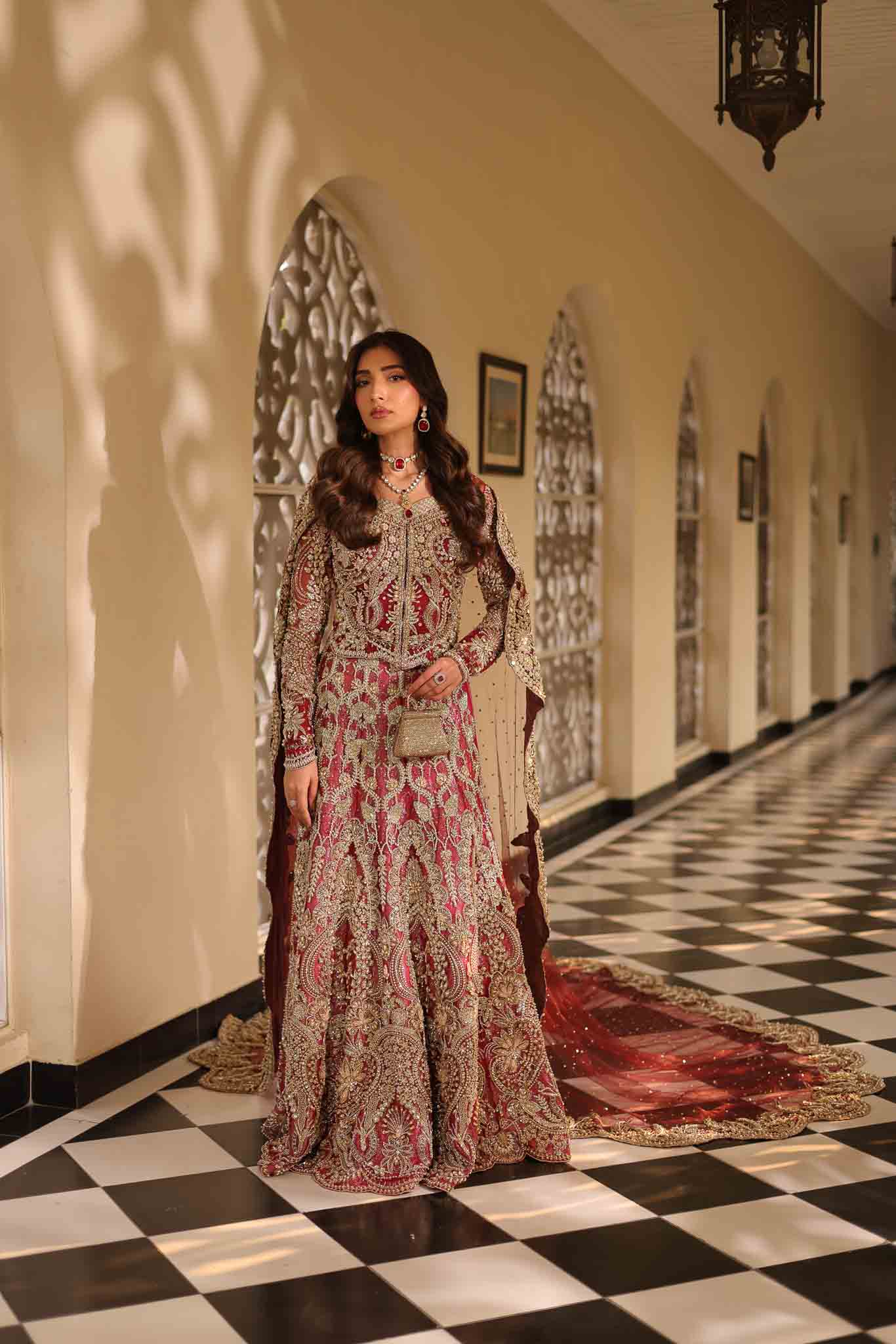 Model wearing deep red and gold bridal gown AURAA from Mysie by Tahira, Pakistani luxury pret available online in UK for weddings.